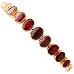 Antique 12.84 Carat Oval Cut Garnet and 9K Yellow Gold Bracelet, Circa 1920