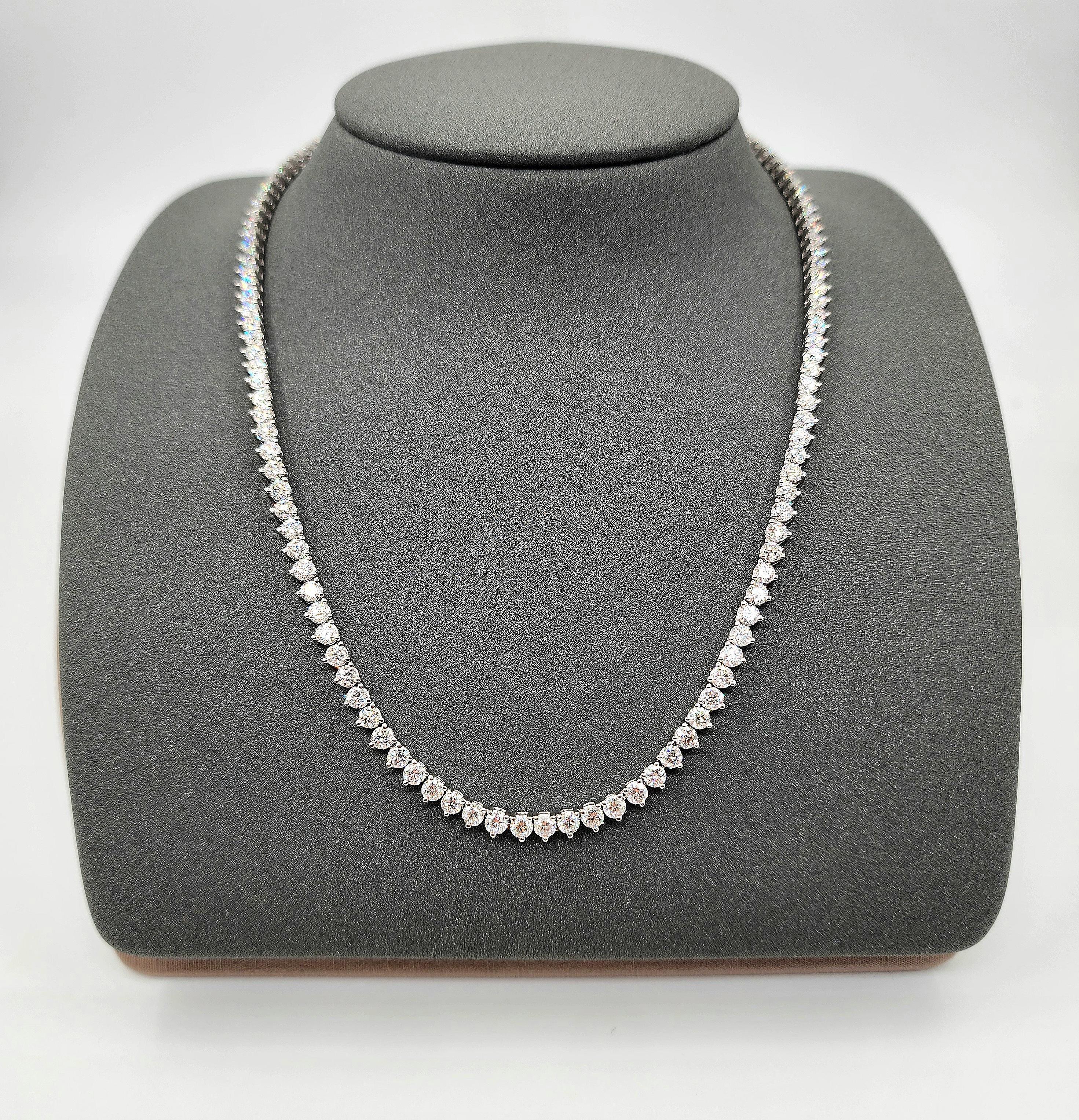 This elegant necklace showcases exceptional artistry. It features 12.84 carats of round-cut white diamonds with a VS2/SI1 clarity and F/G color grade. The 128 diamonds are meticulously set in platinum, offering a sleek, modern look. Crafted in the