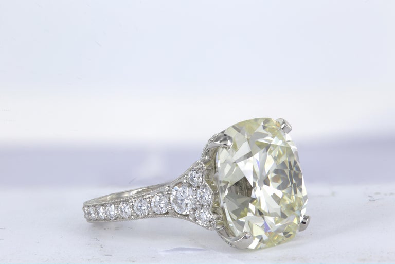 Platinum Diamond ring, featuring one 12.85 carat Cushion cut diamond set into a handmade, hand engraved diamond semi mount with 72 round brilliant cut diamonds weighing a total of 1.21cts.  Size 6
