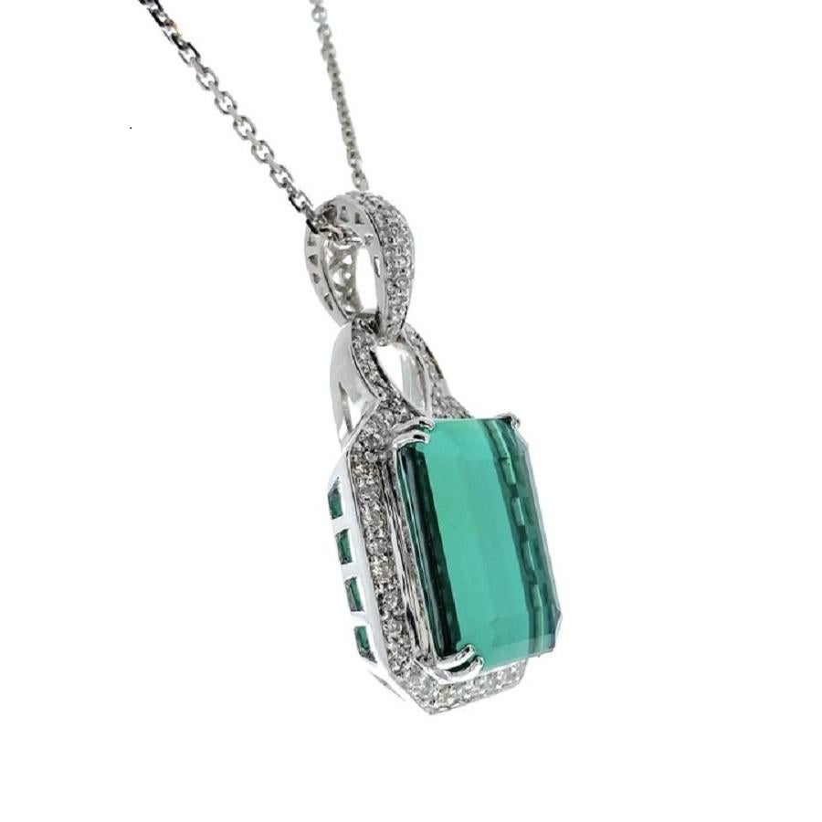Introducing an exquisite fusion of elegance and natural splendor: our breathtaking 12.86 carat Green Emerald Pendant adorned with 65 round diamonds totaling 0.50 carats, all set in luminous 14k white gold. At the heart of this pendant lies a