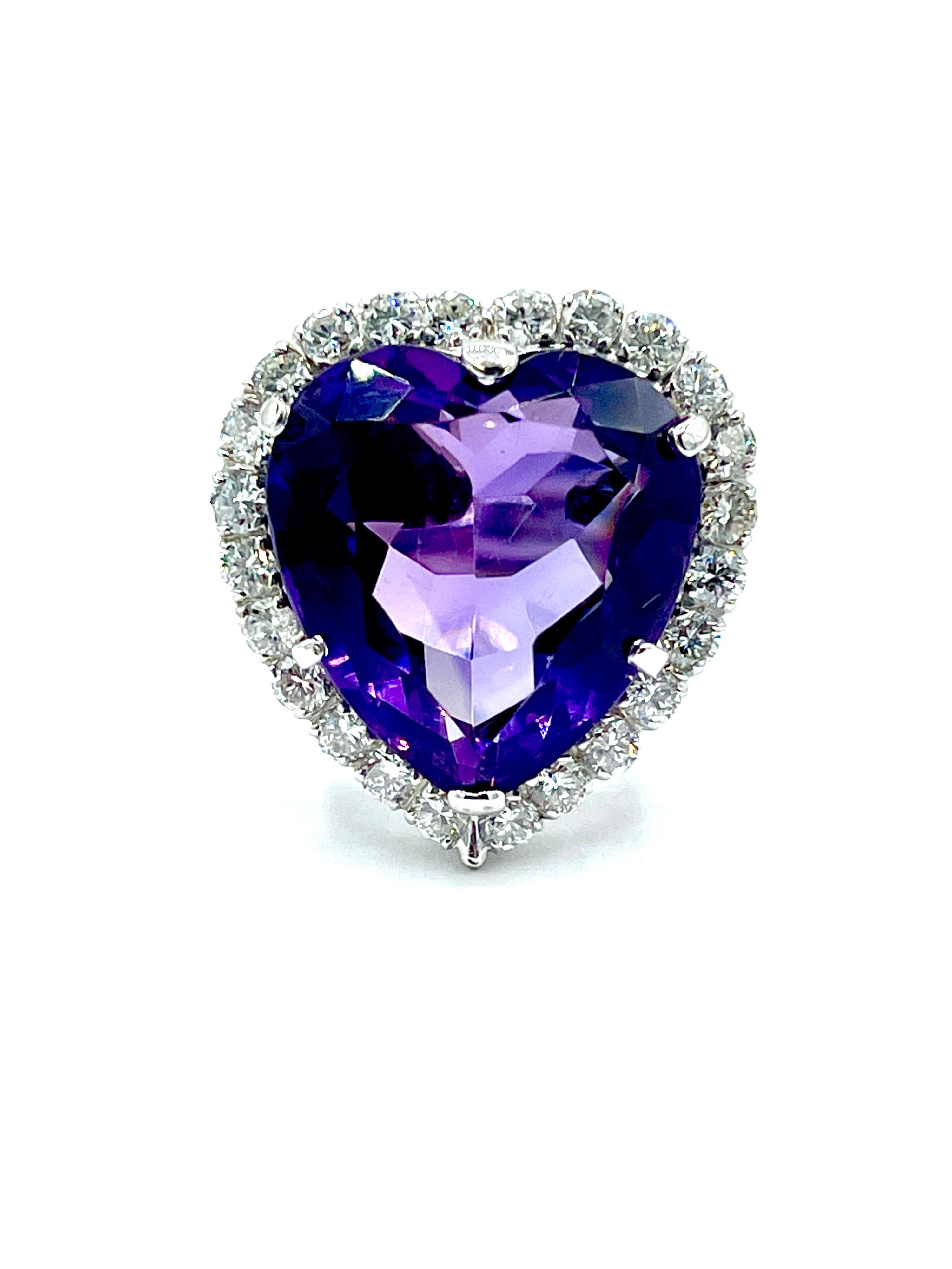 A gorgeous 12.88 carat heart shape Amethyst and round brilliant Diamond 18k white gold cocktail ring.  The Amethyst is set with six prongs, surrounded by a single row of Diamonds totaling 1.20 carats.  The Diamonds are graded as G-H color, VS