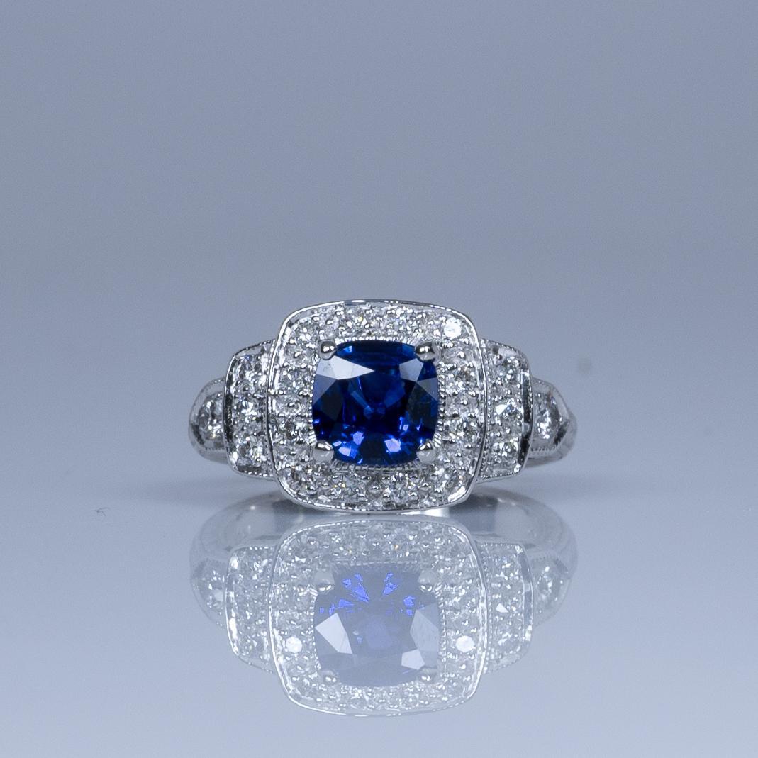 This stunning ring features a 1.28ct GIA-certified cushion cut Ceylon blue sapphire, renowned for its deep, vivid hue and exceptional clarity. Set in a vintage-inspired 14K white gold band, the sapphire is elegantly highlighted by intricate milgrain