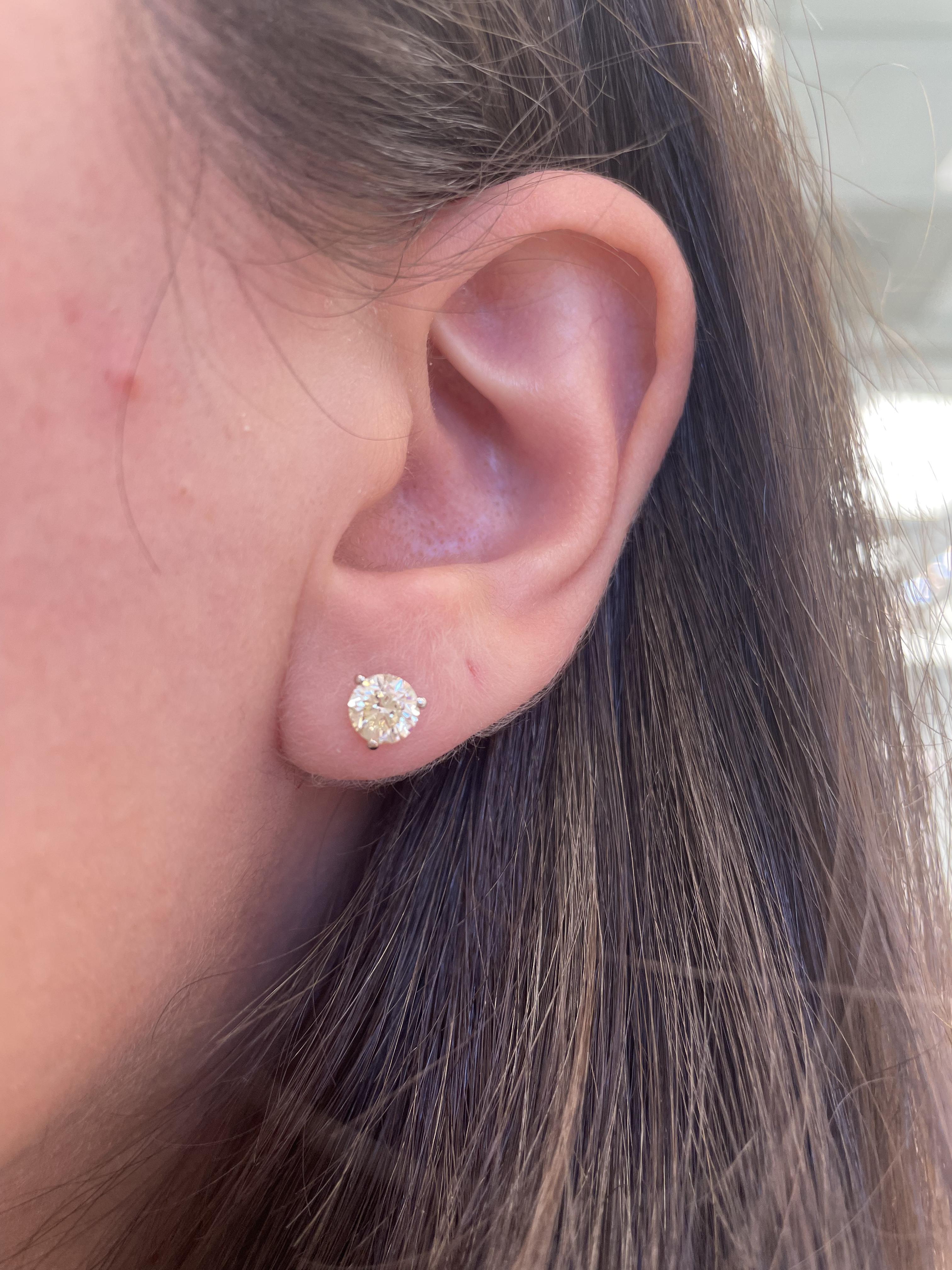 Classic diamond stud earrings.
Two matching round brilliant diamonds 1.28 carats total. Approximately I/J color and VS clarity. Four prong set, 18k white gold, 1.23 grams.
Accommodated with an up-to-date appraisal by a GIA G.G. once purchased, upon