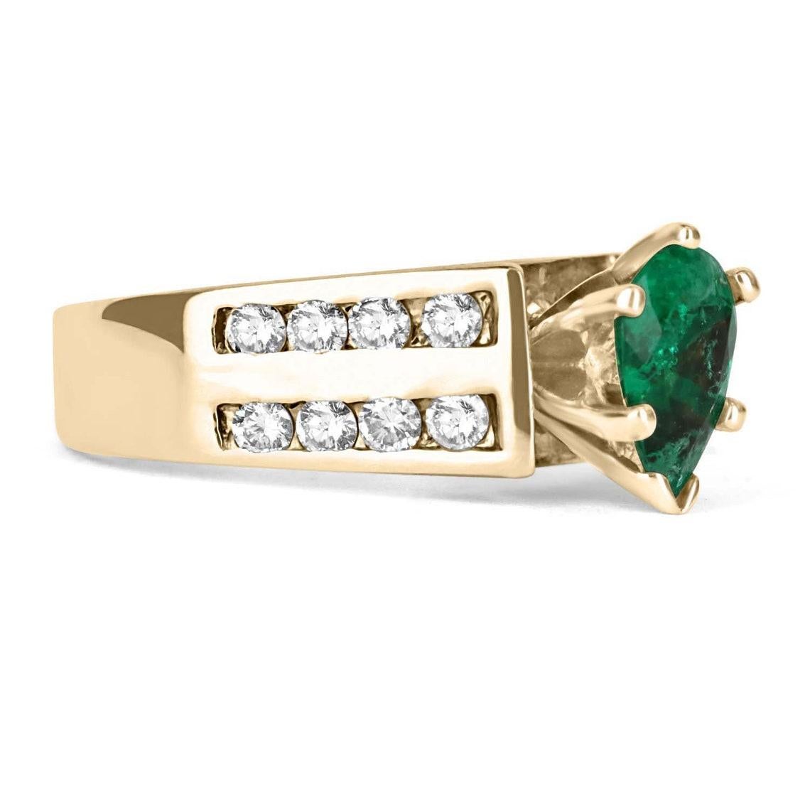 Displayed is a spectacular pear-shaped Colombian emerald and diamond cocktail ring. Set in 14k yellow gold, the sublime emerald weighs a perfect 0.80-carats and is set alongside sixteen high-quality, brilliant round diamonds in a fashionable channel