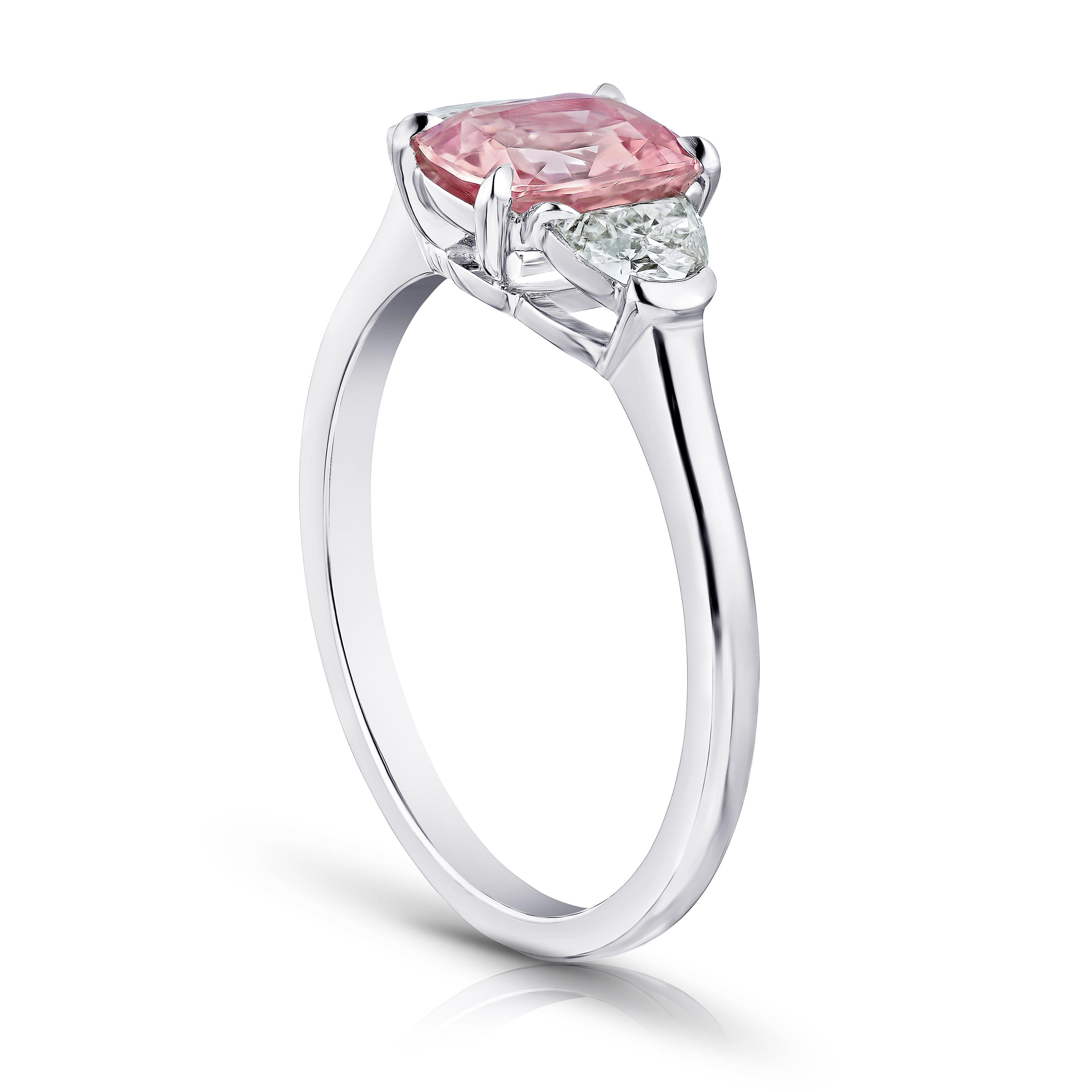 1.29 carat cushion padparadscha sapphire (NH) with half moon diamonds .35 carats set in a platinum ring. This ring is currently a size 7.  We will resize to your finger size without charge.
