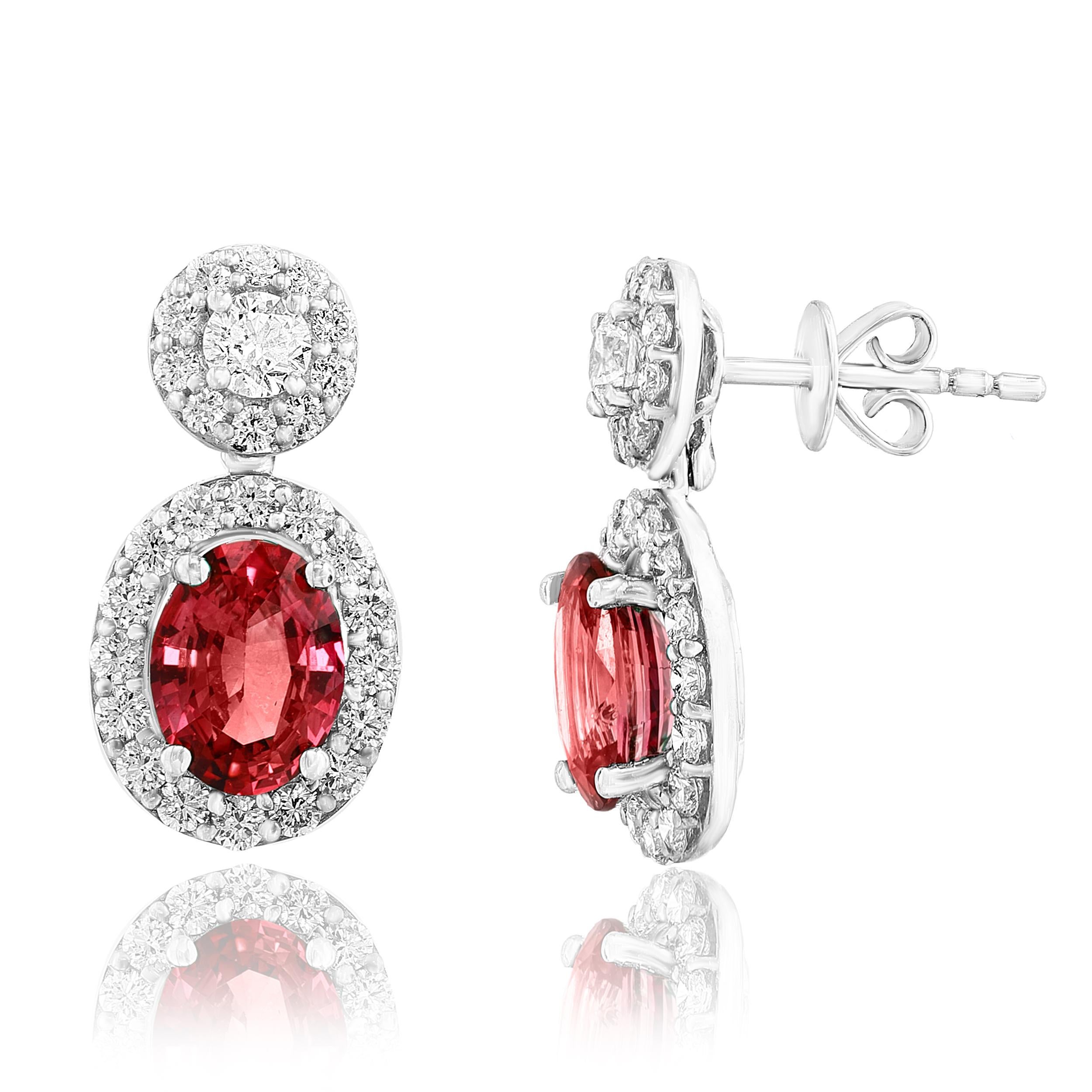 A beautiful and chic pair of drop earrings showcasing brilliant-cut diamonds, and oval-shaped Red Rubies set in an intricate and stylish design. 2  Diamonds on the top weigh 0.36 carats in total.  2  Blue sapphires weigh 1.29 carats in total. Made
