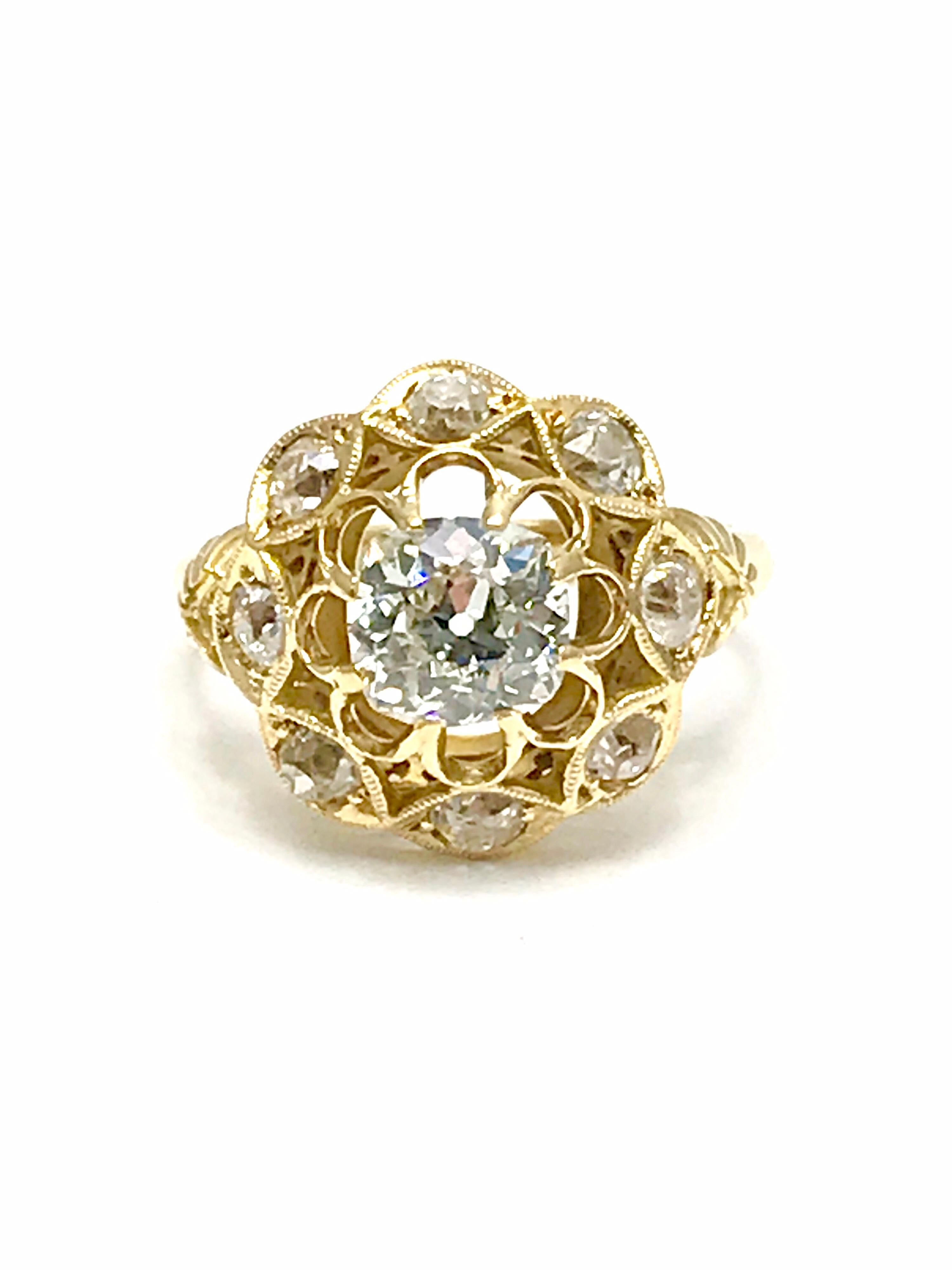 A beautiful 1.29 carat old Mine Cut Diamond engagement/fashion ring set in 18 karat yellow gold.  The ring is designed with the center Diamond set in eight prongs, surrounded by open metal work, and framed by a single row of eight Old Mine Cut