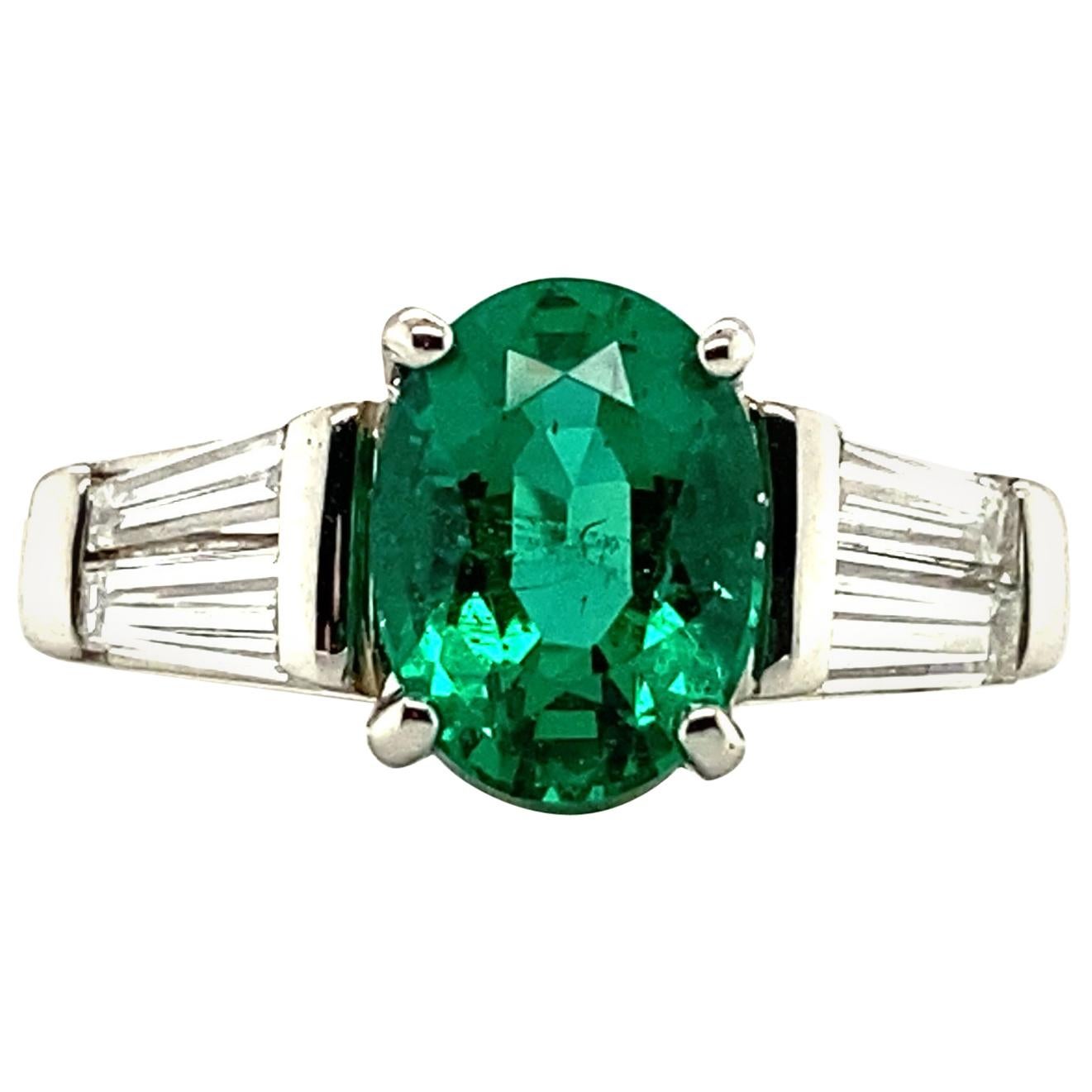 1.29 Carat Oval Emerald and Graduated Baguette Diamond Ring For Sale