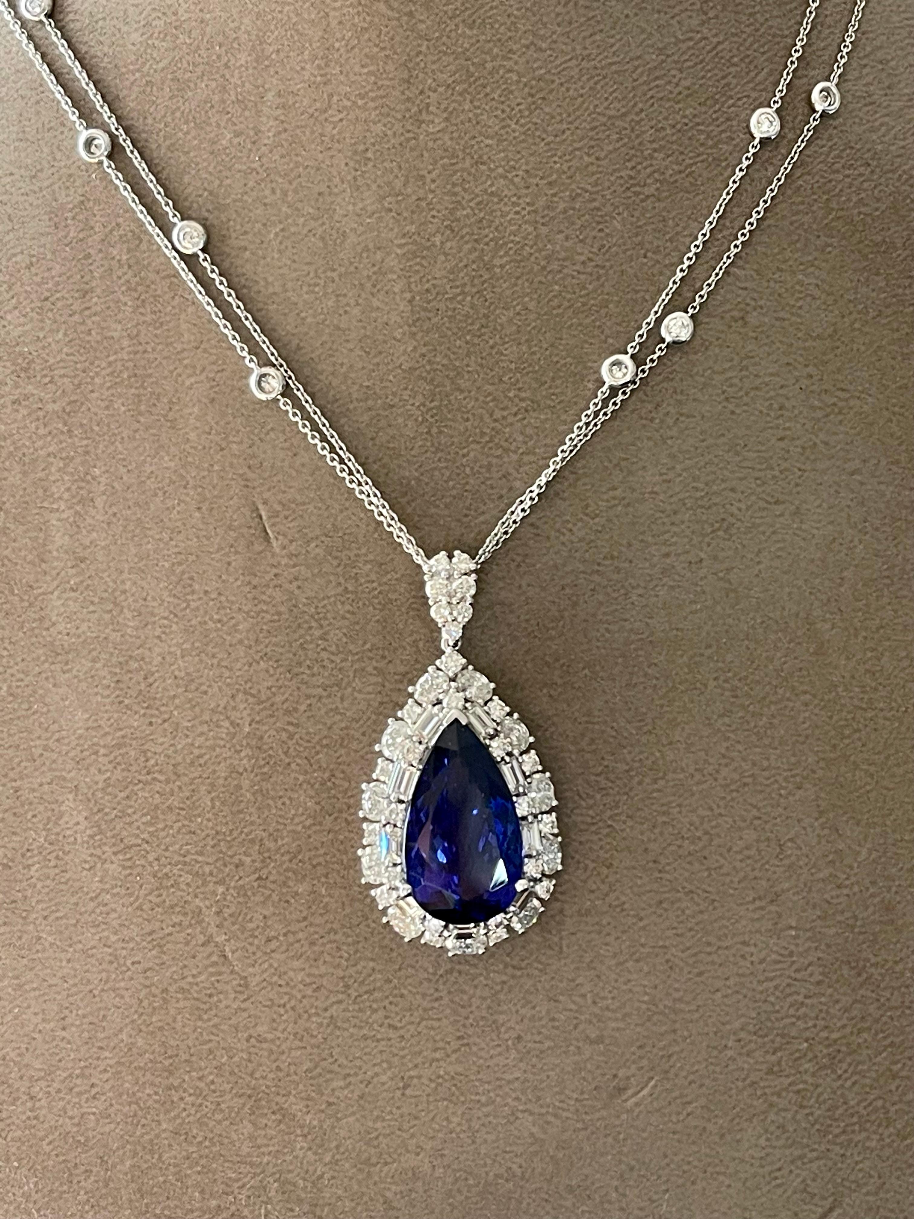 Une très belle Tanzanite en forme de poire pesant 12,90 ct, entourée de 11 diamants ovales pesant 1,49 ct, 9 diamants baguettes pesant 0,71 ct et 39 diamants taille brillant pesant 1,50 ct. Tous les diamants sont de couleur H, I et de pureté si.