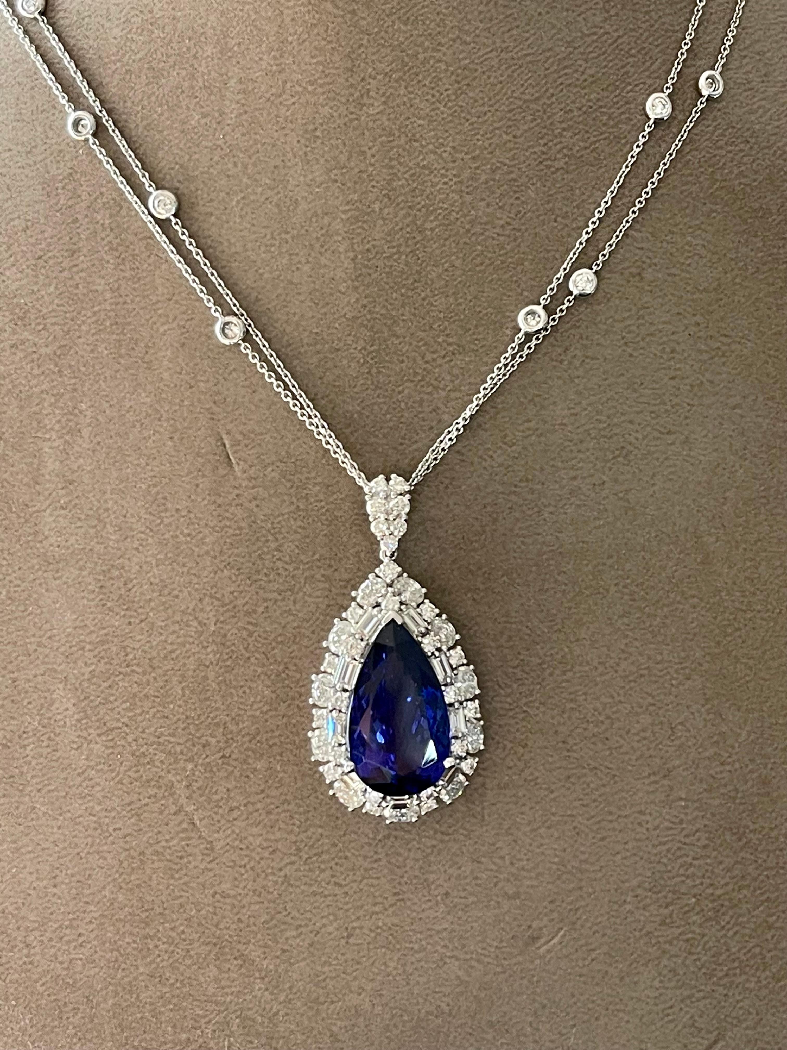 A very fine pear shape Tanzanite weighing 12.90 ct, surrounded by 11 oval Diamonds weighing 1.49 ct, 9 Baguette Diamonds weighing 0.71 ct and 39 brillinat cut Diamonds weighing 1.50 ct. All Diamonds H, I color and si clarity. Mounted in 18 K white