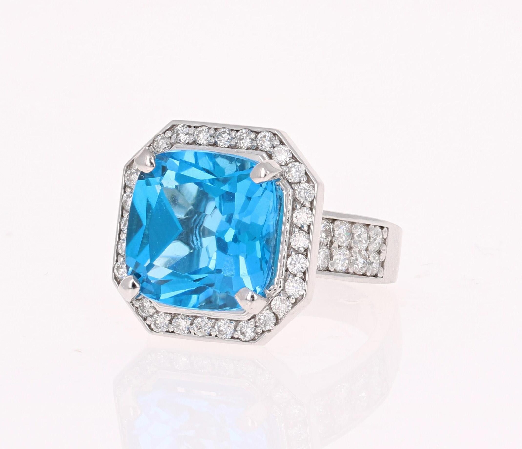 This beautiful Emerald cut Blue Topaz and Diamond ring has a stunningly large Blue Topaz that weighs 11.80 Carats. It is surrounded by 44 Round Cut Diamonds that weigh 1.12 Carats. The total carat weight of the ring is 12.92 Carats. 
The setting is