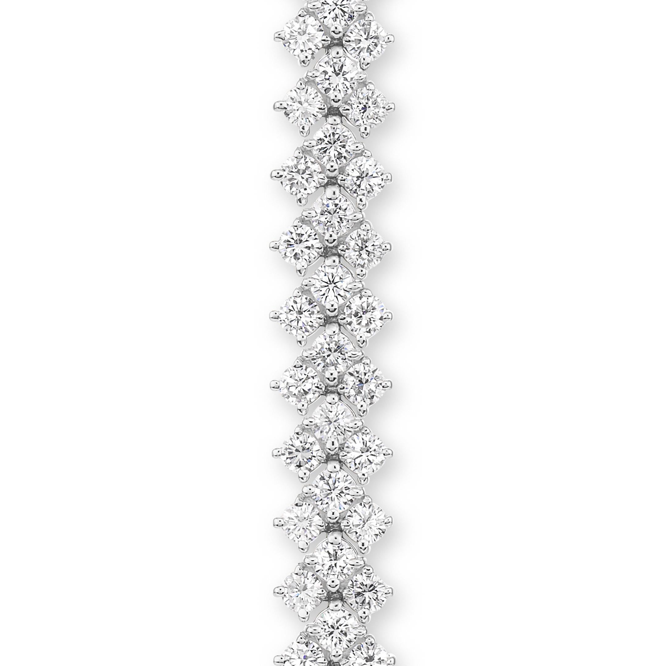 This gorgeous triple row diamond bracelet has 99 stones G color SI that weigh 12.95 ct total weight. It is 7 inches long and 9.5 mm wide. If you don't see something, say something! We would be happy to work with you to create your dream bracelet!