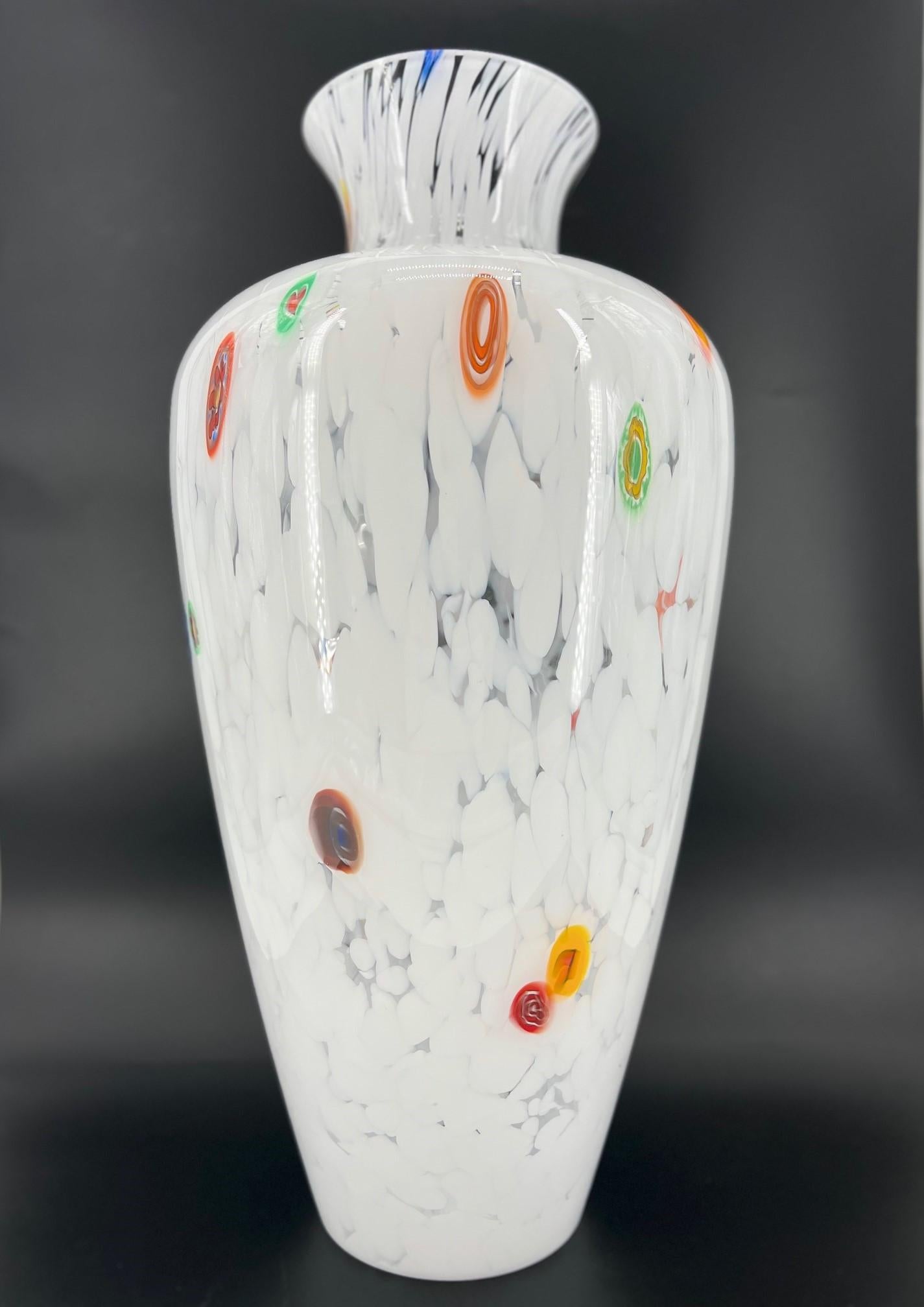 Our primary goal is to evoke emotions through the creation of unique and exquisite Murano glass art pieces. This particular art-vase is made from high-quality white blown glass and features an outer layer of colorful Murano Murrine. Each piece is