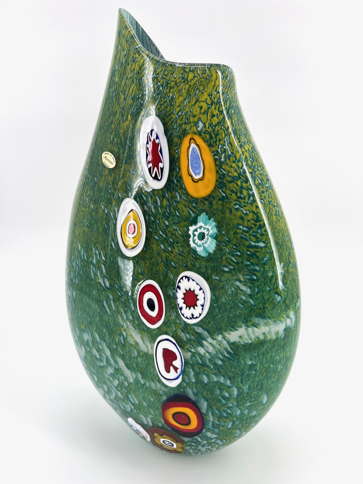 Our aim is the emotion through the creation of Murano glass artpieces.
 
Our Master hand make and blown beautifly this artvase with green nouanced Murano glass and colorful Murrine , that gives to this artpiece a nice and unique combinations of