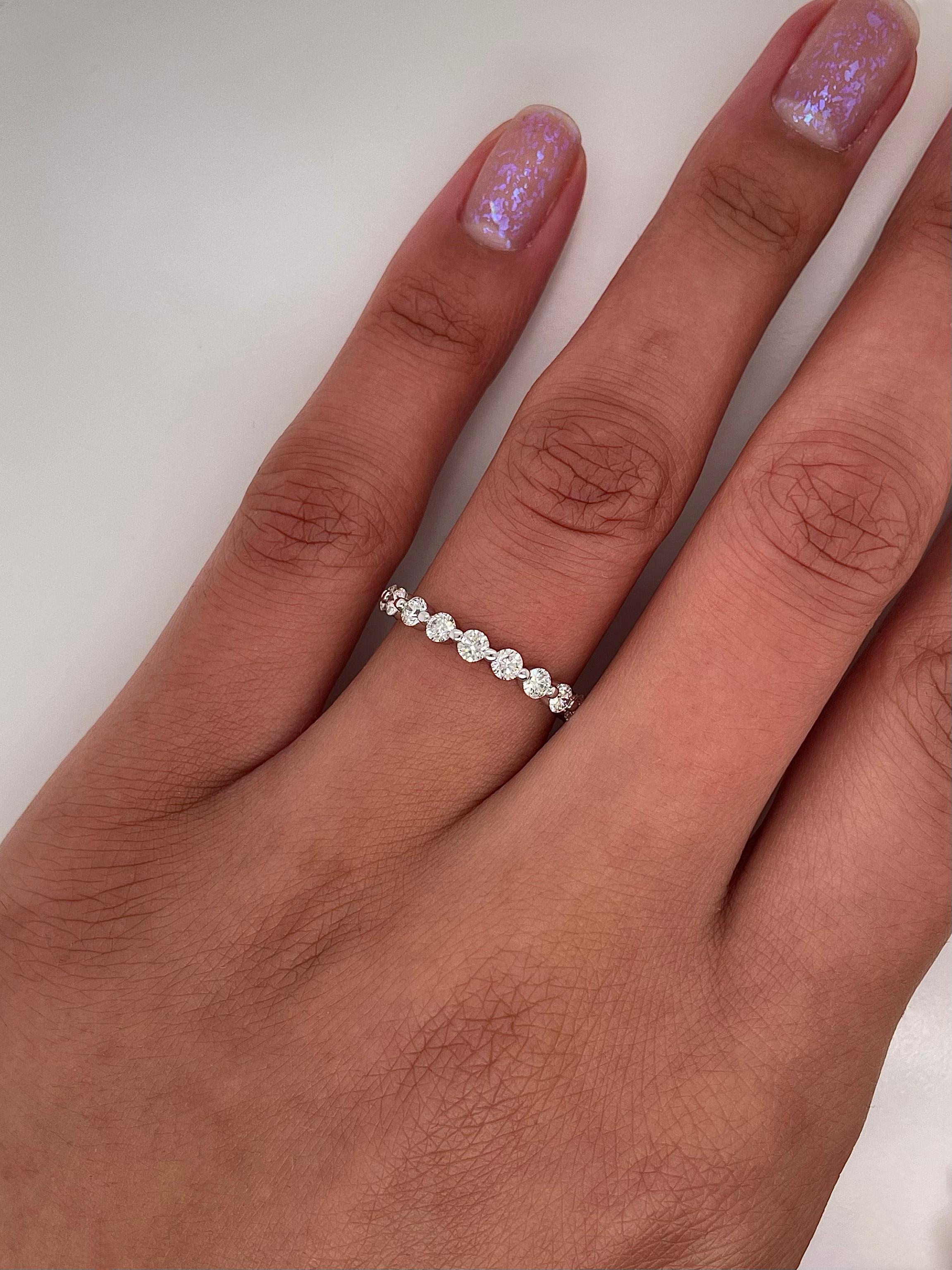 Ladies diamond Eternity band carries 1.29ct of brilliant cut diamonds placed in 14K white gold.

Size: 6.0
Color: G-H
Clarity: SI

This shared prong style Eternity band was handmade by our jewelers in New York City.