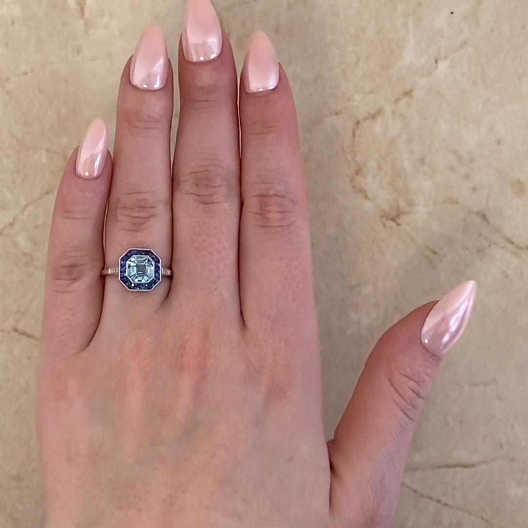 This exquisite ring features a mesmerizing approx. 1.20-carat Asscher-cut aquamarine at its center, set in a sleek bezel setting. The aquamarine’s crisp, clean facets capture and reflect light beautifully, evoking an air of elegance and