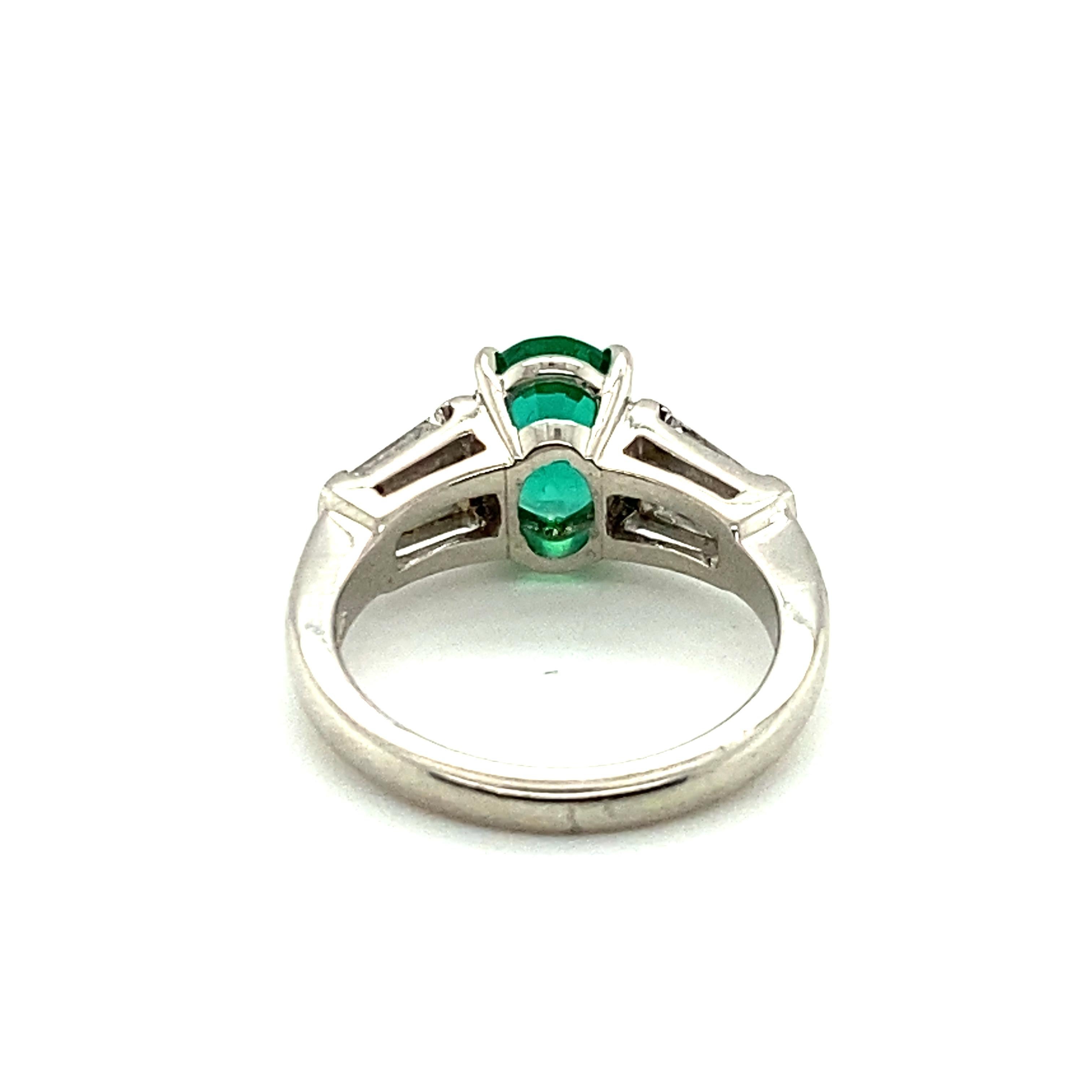Oval Cut 1.29 Carat Oval Emerald and Graduated Baguette Diamond Ring For Sale