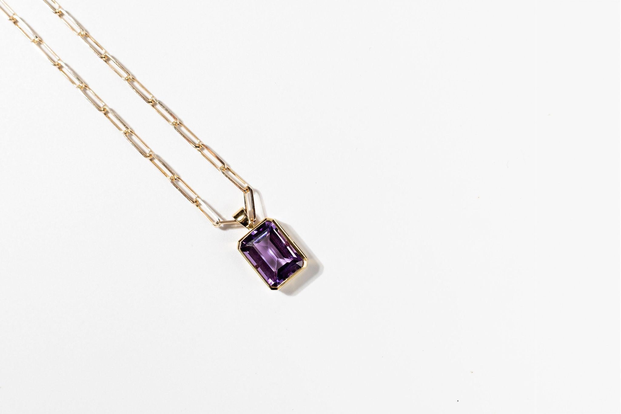  12carat AAA dark purple Amethyst pendant set in 14k yellow gold. It sits on a beautiful 14k gold Paperclip chain. The pendant bale is large enough that the pendant can be removed. It is a contemporary design and is one of three Maadrn made. The