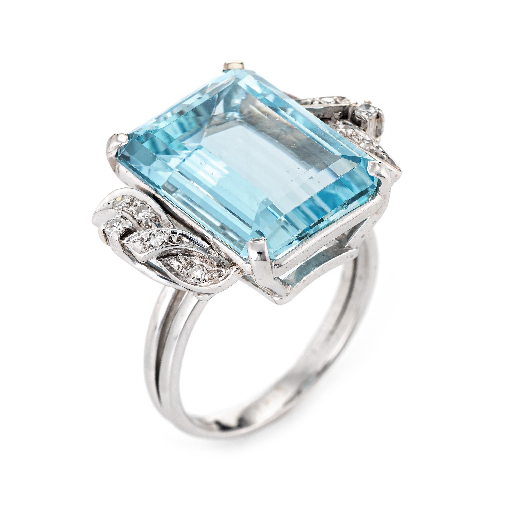 Stylish vintage aquamarine & diamond cocktail ring (circa 1950s to 1960s) crafted in 18 karat yellow gold with platinum accents. 

Emerald cut aquamarine measures 16mm x 12.5mm (estimated at 12 carats), accented with 0.11 carats of diamonds. The