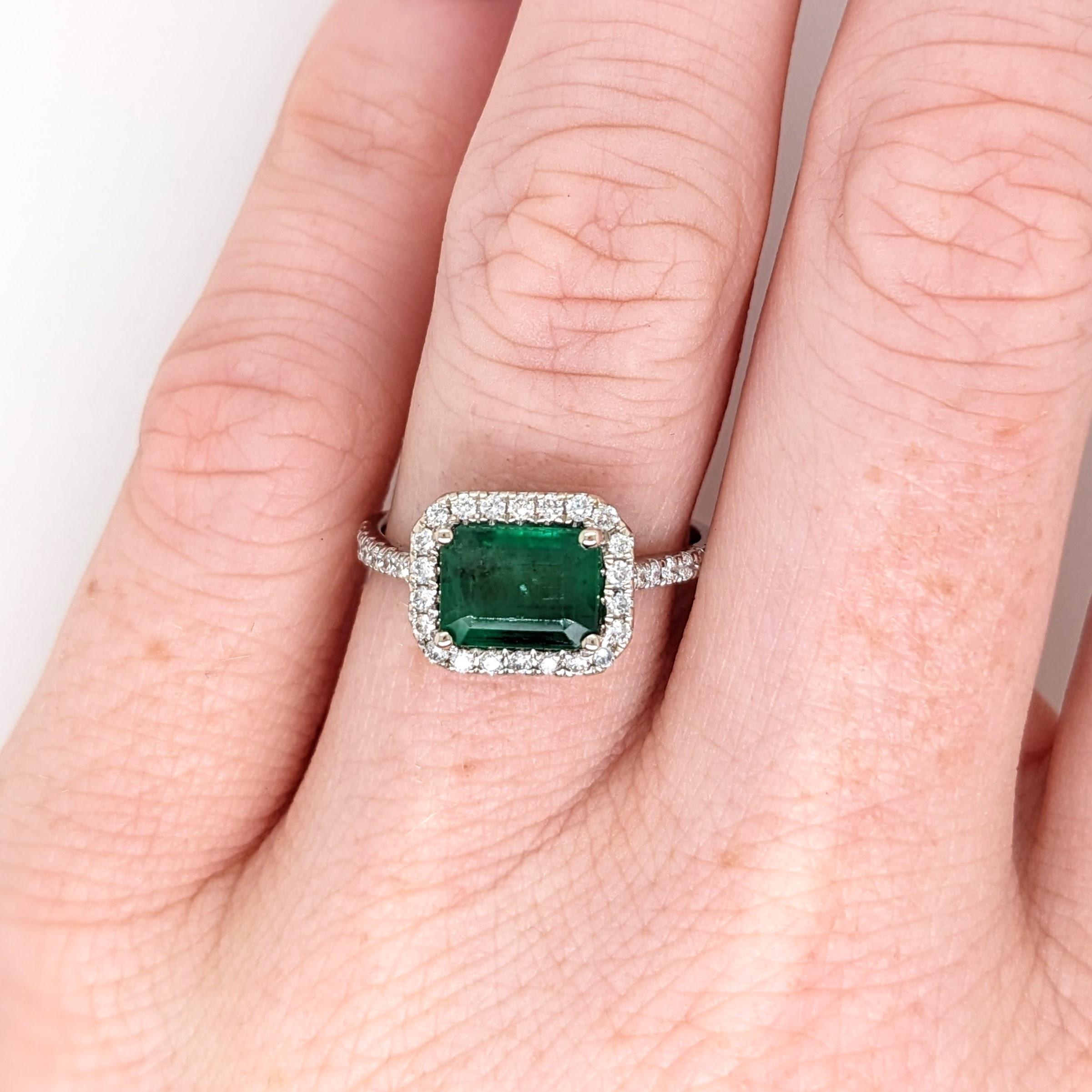 This classic NNJ ring design features a 1.21 carat east west emerald gemstone with natural earth-mined diamonds all set in 14k gold and can be customized to fit your needs. This ring also makes a beautiful May birthstone ring for your loved