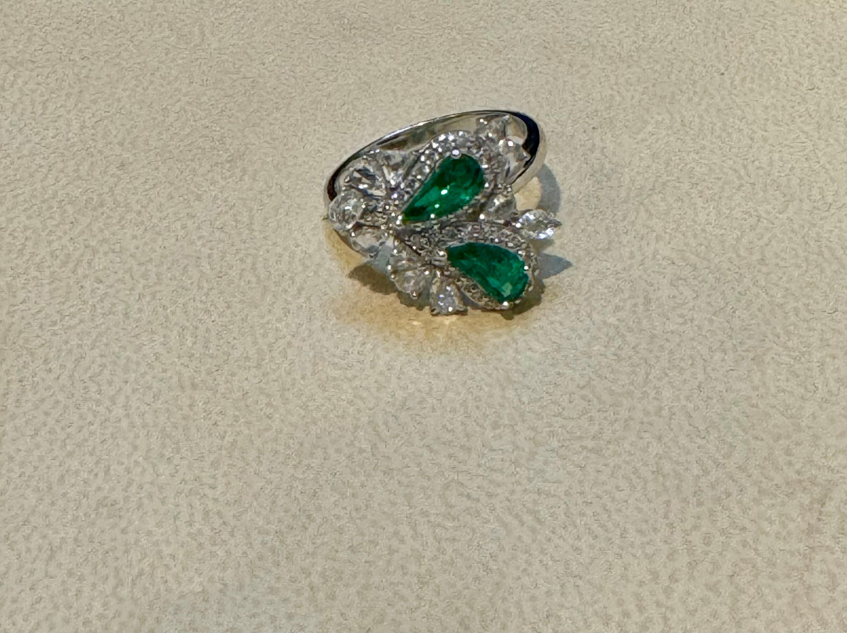 1.2Ct Finest Zambian Fancy pear  Emerald & 1.3Ct Diamond Ring, 18 Kt Gold ,  size 7
 This classic ring features a two fancy pear cut Zambian emerald of extreme fine quality, boasting a desirable color and luster, originating from Zambia. Accompanied