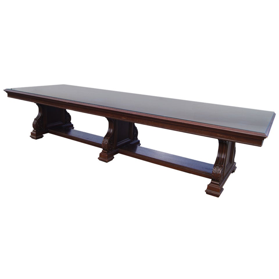 Baroque style 12 Ft. Royal Dutch/Shell Group Roxana Petroleum Corporation oak conference table. 
This magnificent table is constructed from solid oak and features three hand carved oak pedestal legs with intricate motifs and scroll work. Dark walnut