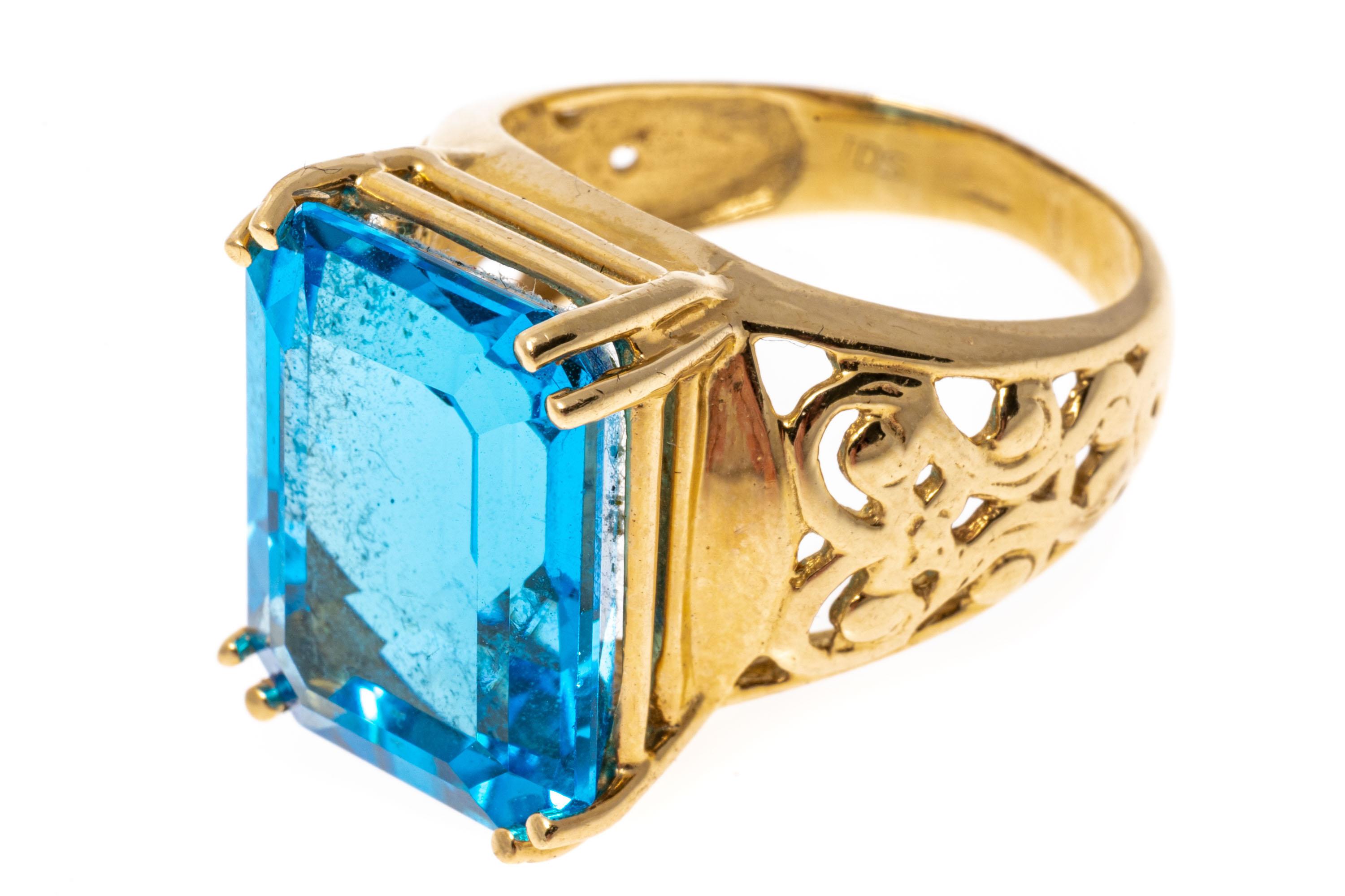 Contemporary 12k Gold Large Emerald Cut Deep Blue Color Blue Topaz Pierced Ring For Sale