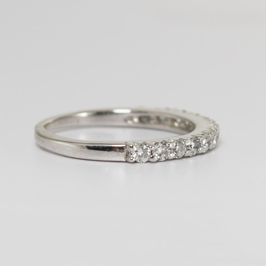 Vintage 12k white gold diamond ring.
Tests 12k gold and weighs 1.5 grams.
Prong set diamonds cover the top half of the ring.
The diamonds are round brilliants, .32 total carats, H to I color, and Si clarity.
The ring measures 2mm thick.
Ring size is