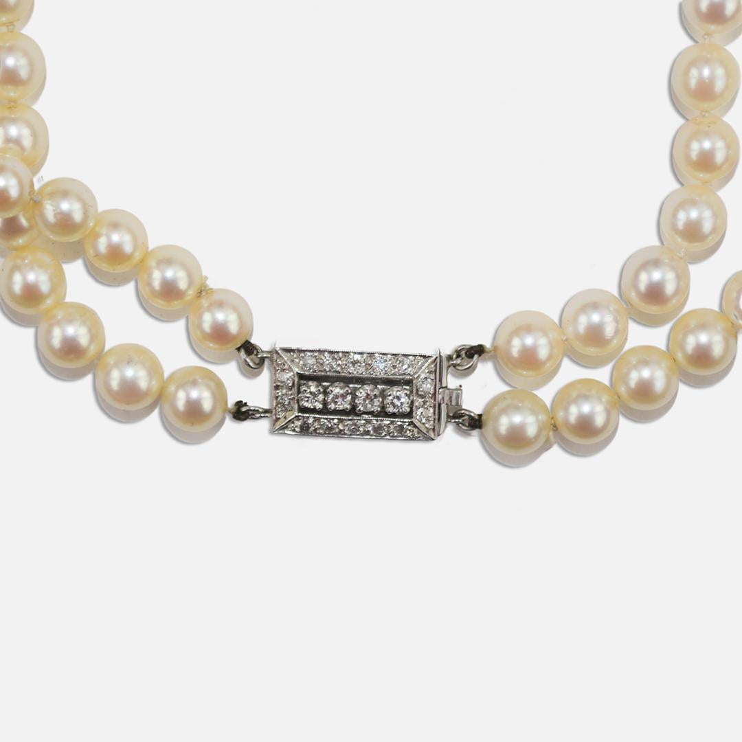 Vintage double strand pearl necklace with 12k white gold diamond clasp.
The clasp tests 55% gold with an XRF Metals analyzer.
The diamonds in the clasp are round brilliant cuts, .30 total carats, and good quality.
The pearls are saltwater cultured,