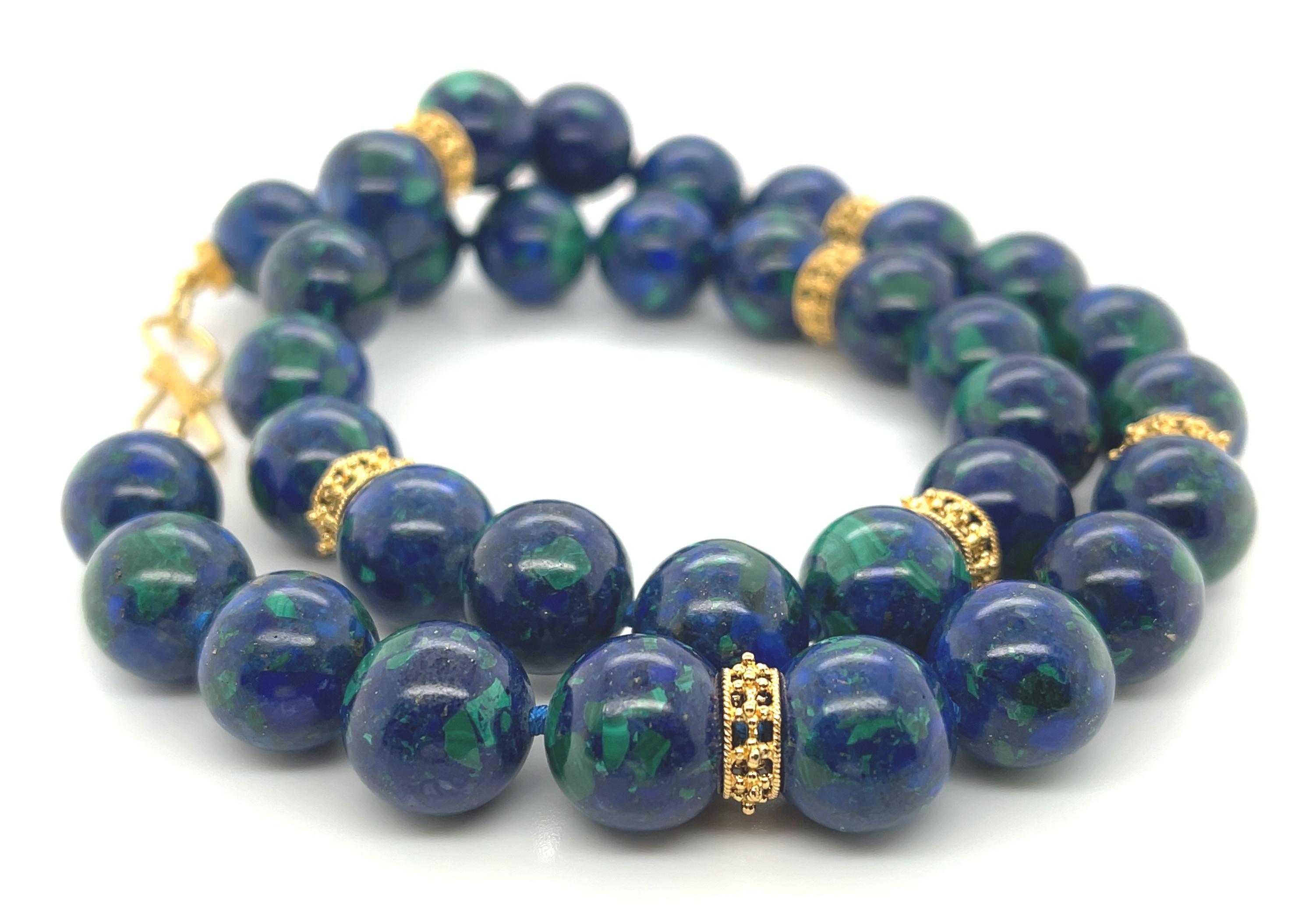 This eye-catching necklace features colorful azurite-malachite beads arranged with decorative 18k yellow gold accents. The large, round 12mm beads are naturally comprised of royal blue azurite and rich green malachite that make each bead look like