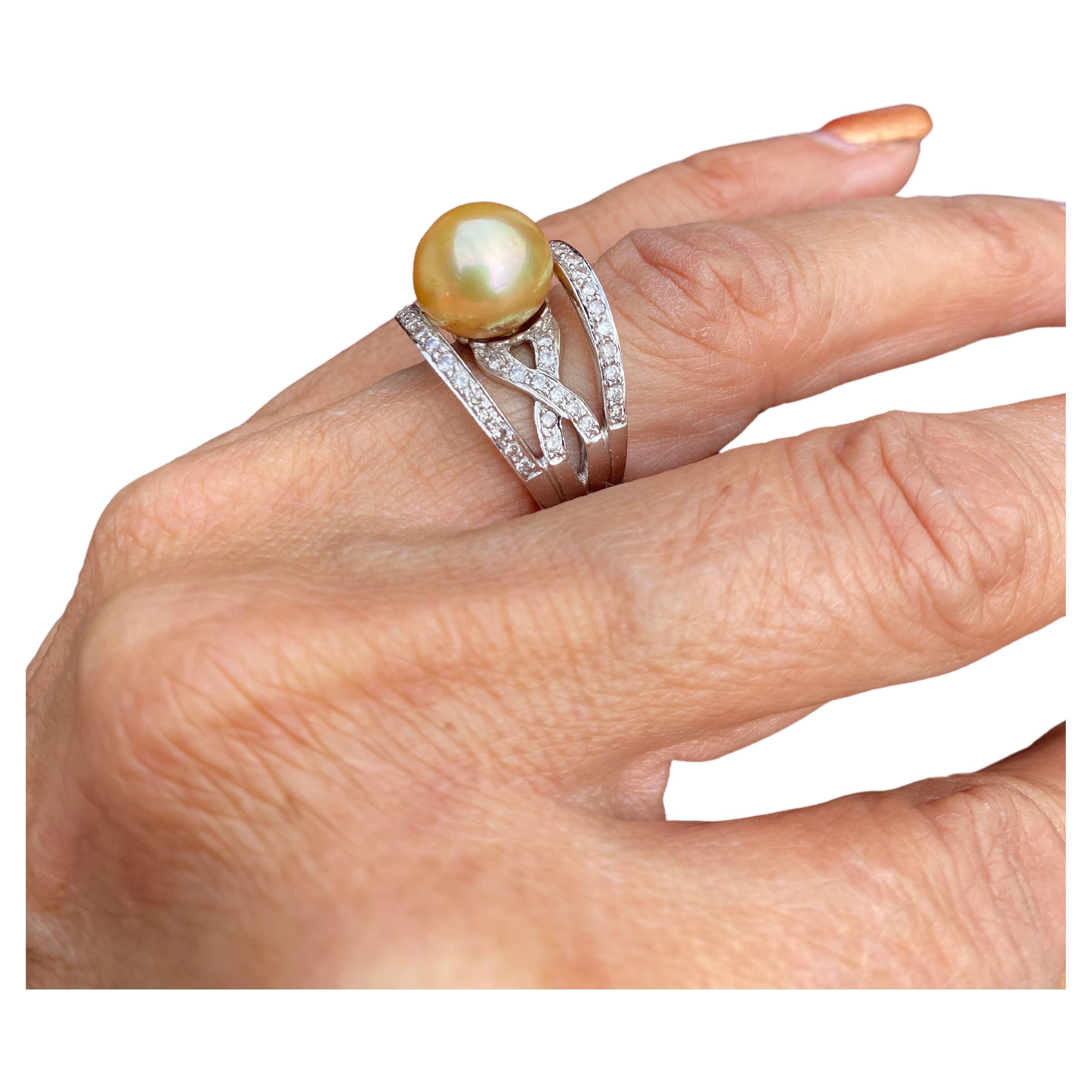 The ring is 16 mm wide with a quality 12mm Golden Pearl centered. The pearl's quality is A quality with very few blemishes.
Diamonds are paved and set in a modern contemporary design having a total weight of .87 carat (inscribed on the inside of the