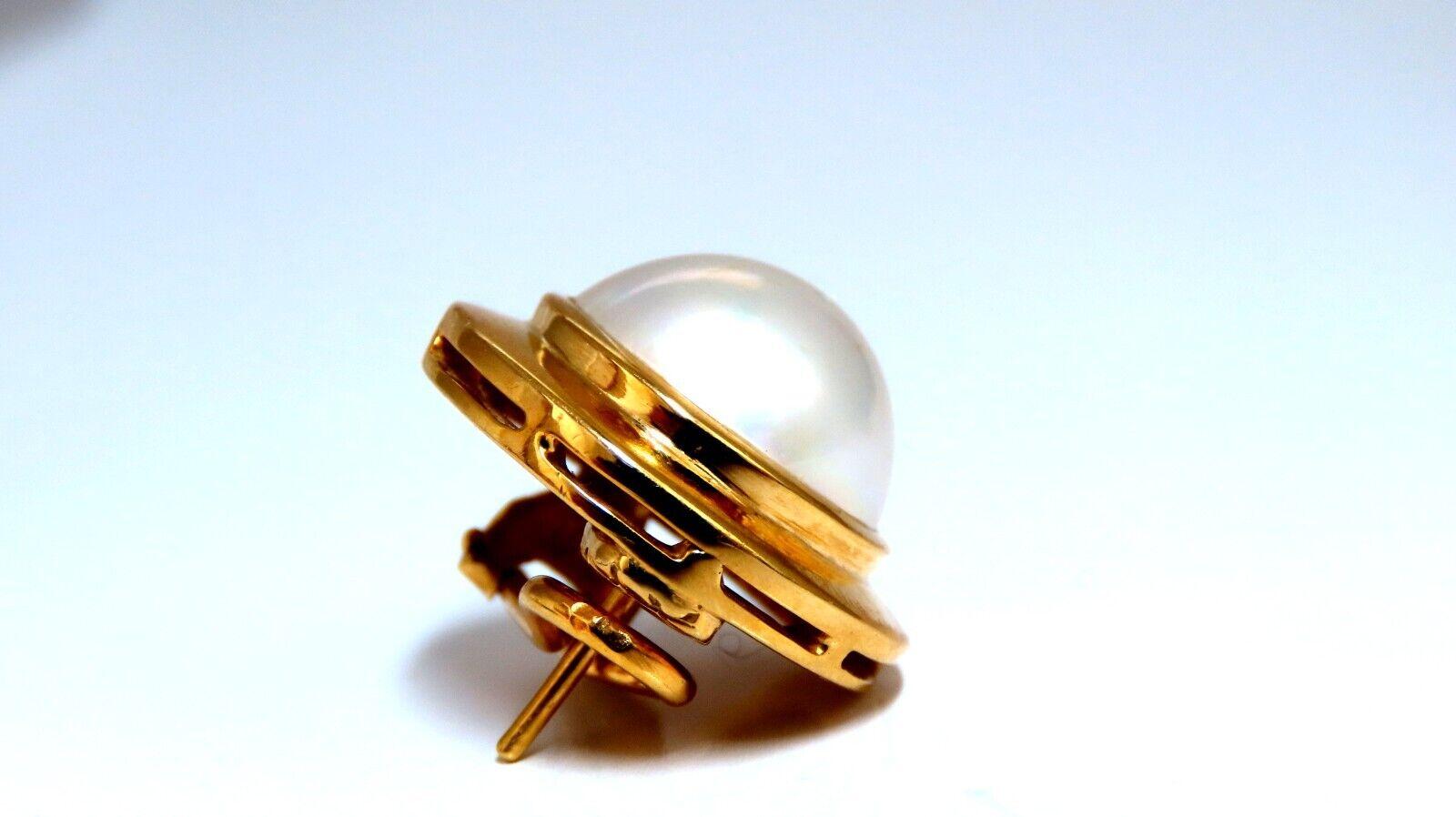 Mabe Pearl clip earrings.

12mm Pearl

Excellent AAA luster and Sheen silver overtone

18 karat yellow gold 20 grams

Overall earrings measure 19mm wide

15 mm depth.

Comfortable Omega Clip.