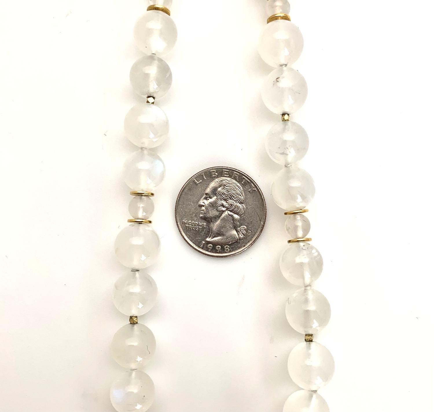This stunning moonstone beaded necklace has an ethereal glow, featuring unusually large, 12mm round moonstone beads that have been hand-strung with smaller round moonstone beads. 22k yellow gold discs, spacers, and an 18k yellow gold lobster clasp