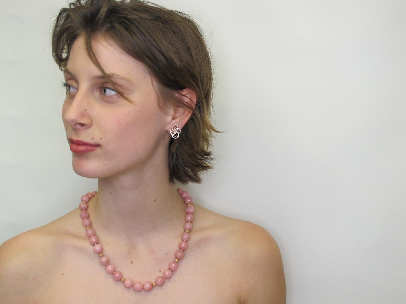 This unusual beaded necklace features large, 12mm round pink Peruvian opals beads in a lovely shade of peony pink! The opals have been hand strung with 14k rose gold accents and will make a unique and flattering  addition to your jewelry collection!