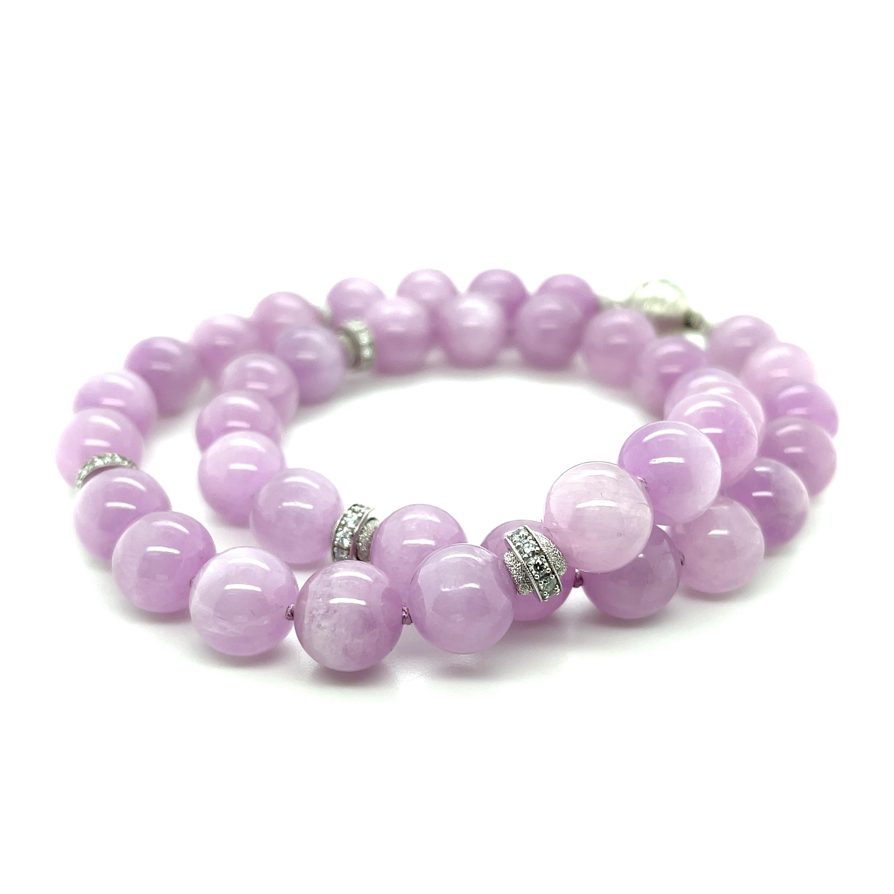 This beautiful, eye-catching necklace features an unusual collection of gorgeous 12mm round kunzite beads paired with white gold and diamonds. The kunzite beads are a lovely purplish pink and are semi-opaque, with a hint of translucence that gives