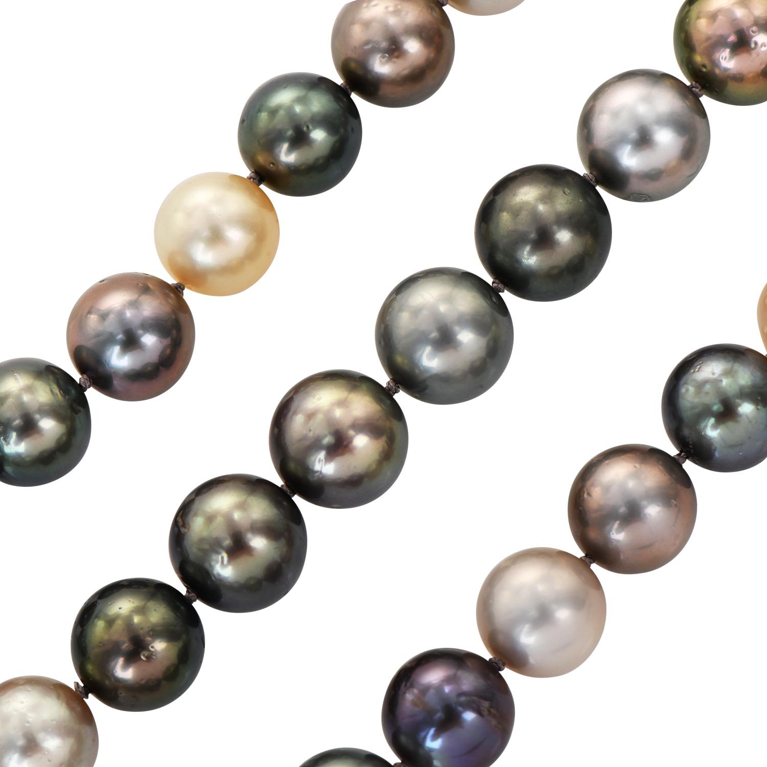 A long strand of High lustrous Tahitian & Golden South Sea Pearls of uniform 12 mm.

A multicolor dance of black, gray, peacock, silver & golden pearls makes this necklace a unique match of beauty and glamour.

The circular two-tone clasp is crafted
