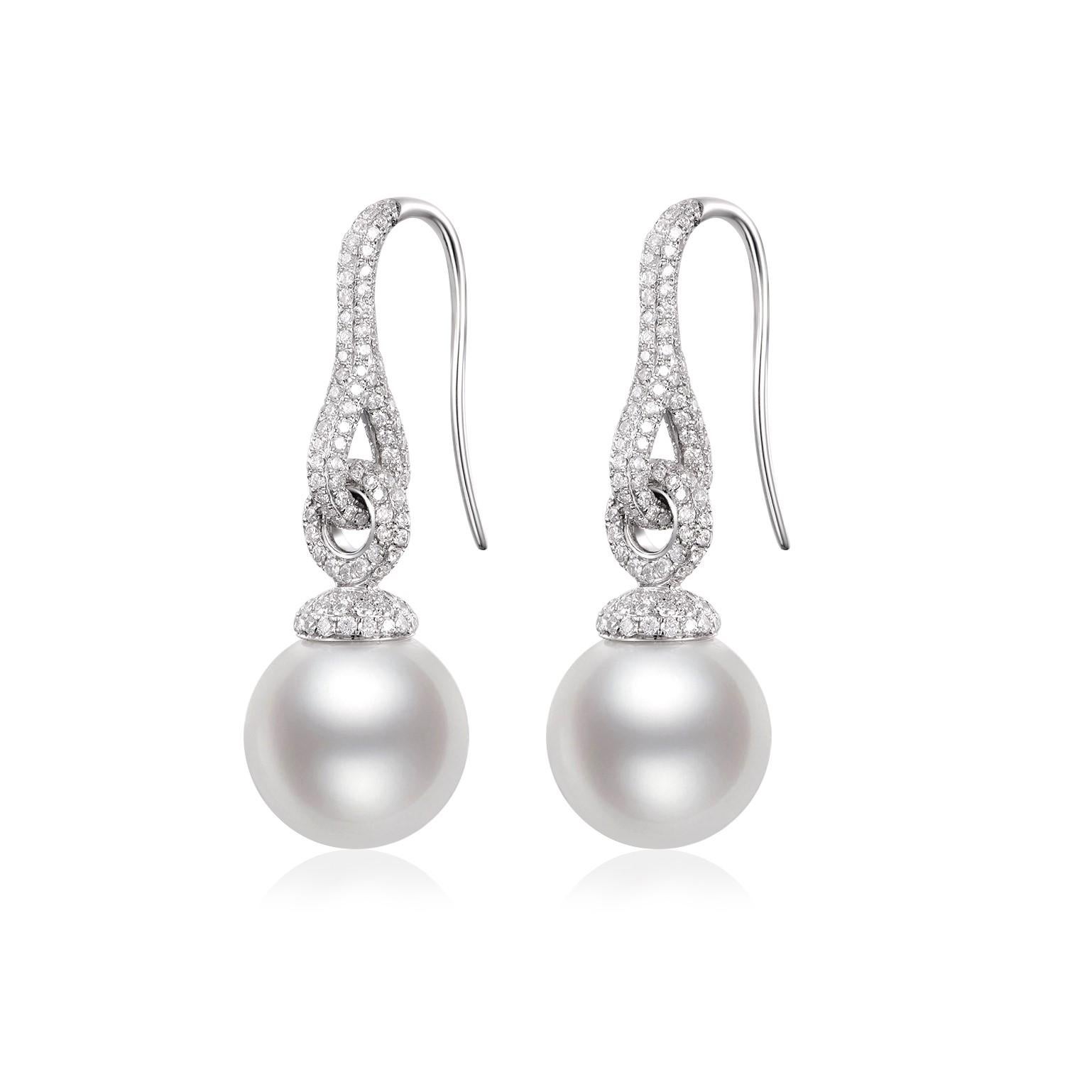 Elegance finds its epitome in the South Sea Pearl Diamond Dangle Earrings. Crafted in pristine 14 Karat White Gold, this pair is a sublime expression of luxury and artistry. At the heart of each earring is a breathtaking 12mm South Sea pearl. Known