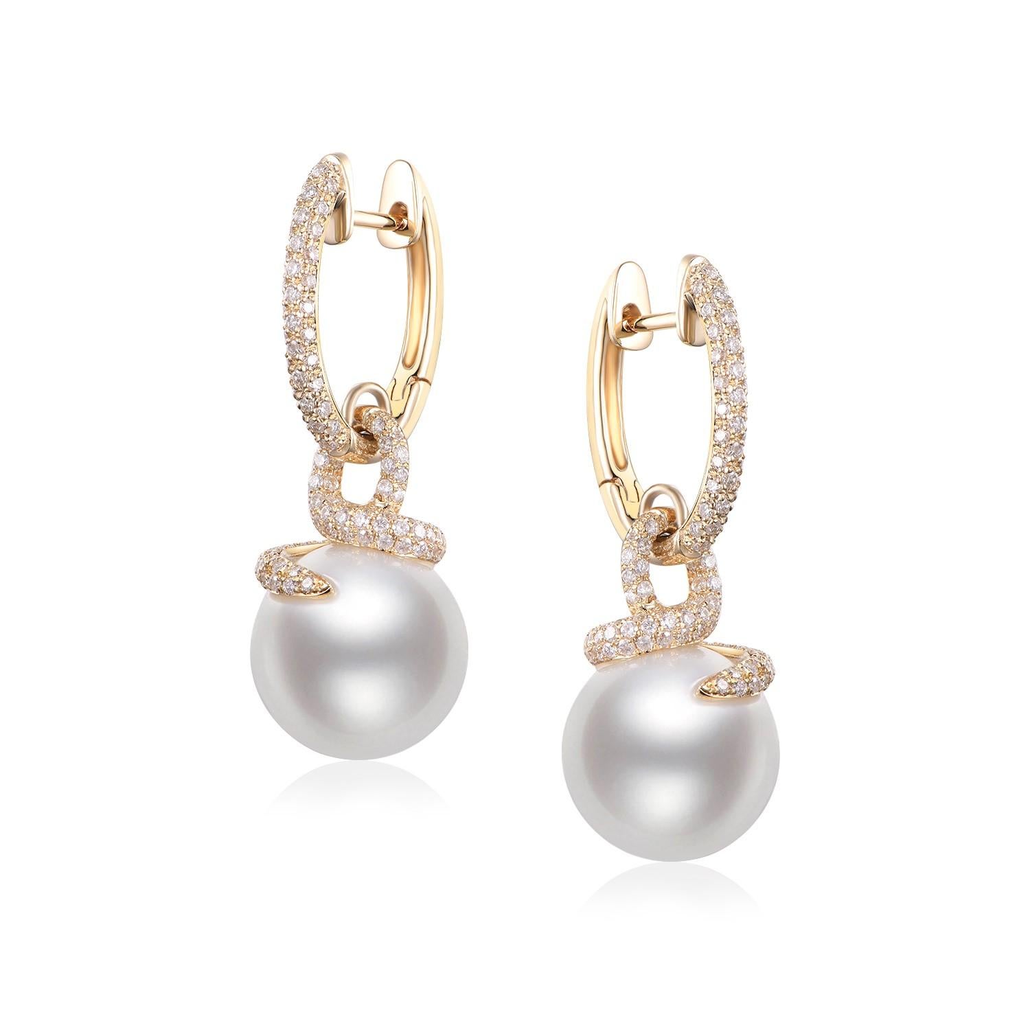 The South Sea Pearl Diamond Drop Earrings, beautifully set in 14 Karat Yellow Gold, are a timeless testament to the delicate dance between nature's majesty and human artistry. Each earring boasts an impressive 12mm South Sea pearl, known worldwide
