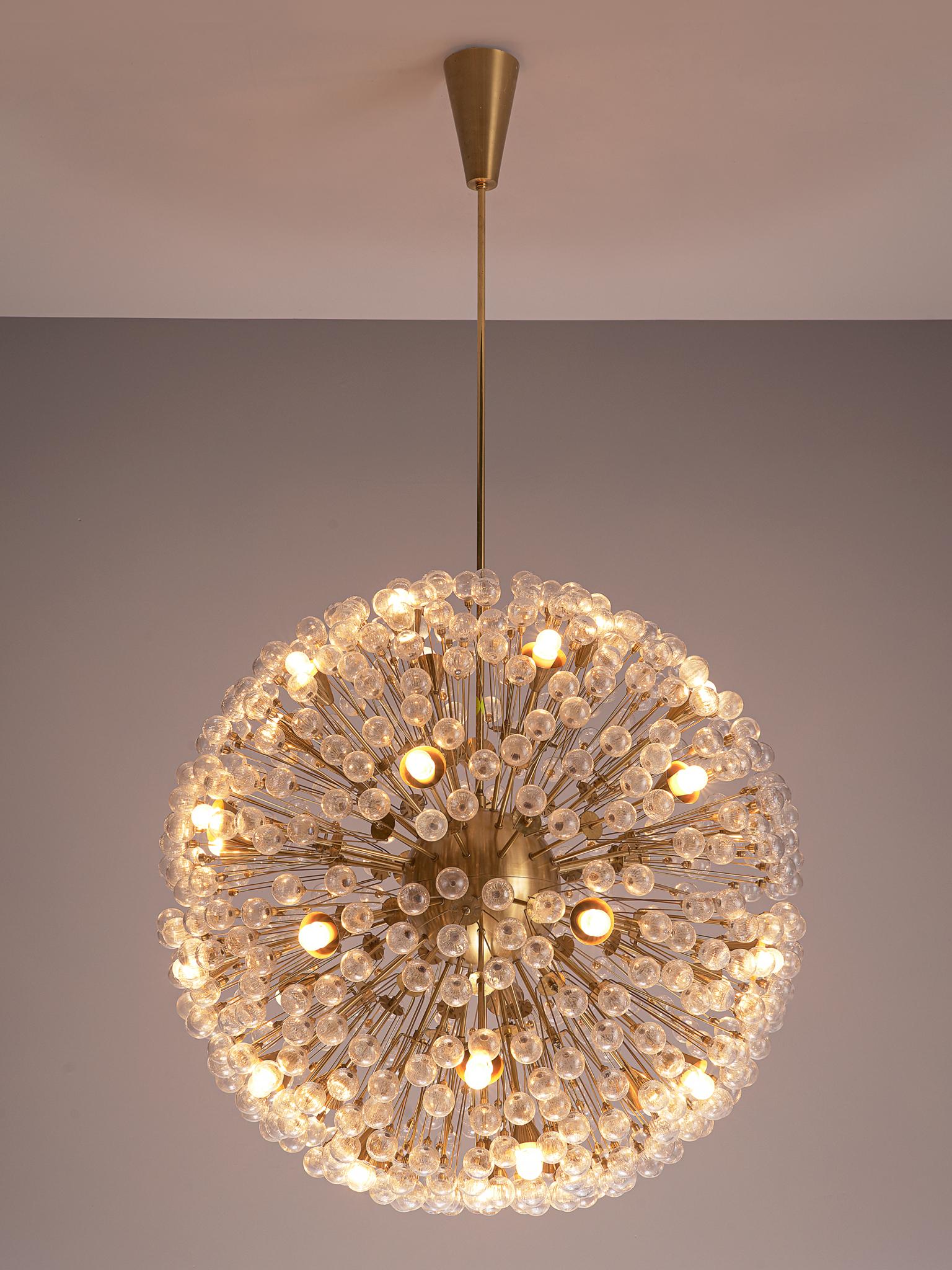 'Sputnik' chandeliers, brass and glass, Austria, 1960s.

The brass sputnik shaped frame is very elegantly finished with several diamond shaped glass ornaments and faceted glass beads. The glass absorb the light very nice which creates a wonderful