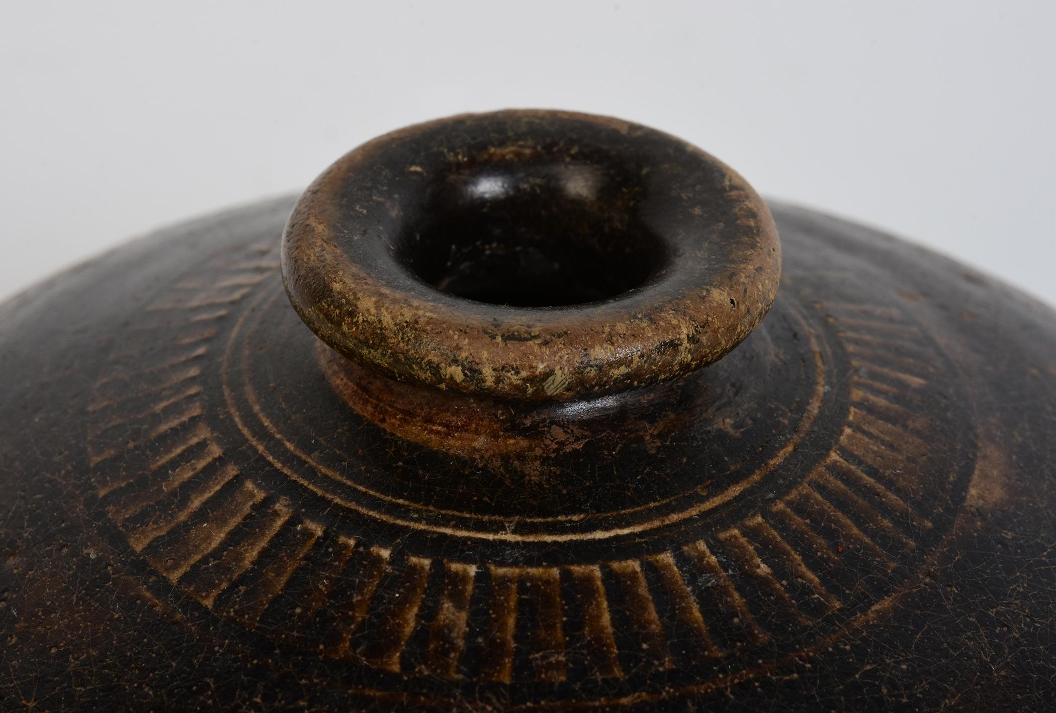 Antique Khmer dark-brown glazed pottery honey pot.

Age: Cambodia, Bayon Period, 12th - 13th Century
Size: Height 9 C.M. / Width 13.8 C.M.
Condition: Nice glaze and condition overall (some glaze chips and natural wearings).

100% Satisfaction and