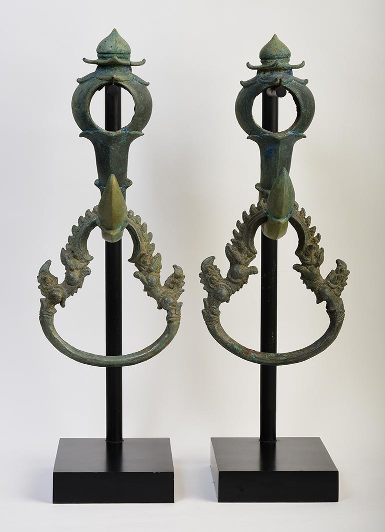 A pair of Khmer bronze palanquin hooks and rings.

Age: Cambodia, Angkor Vat Period, 12th Century
Size: Height including stand 55.8 C.M.
Size of hook and ring: Height 40.5 C.M. / Width 18.5 C.M.
Condition: Nice condition overall (some expected