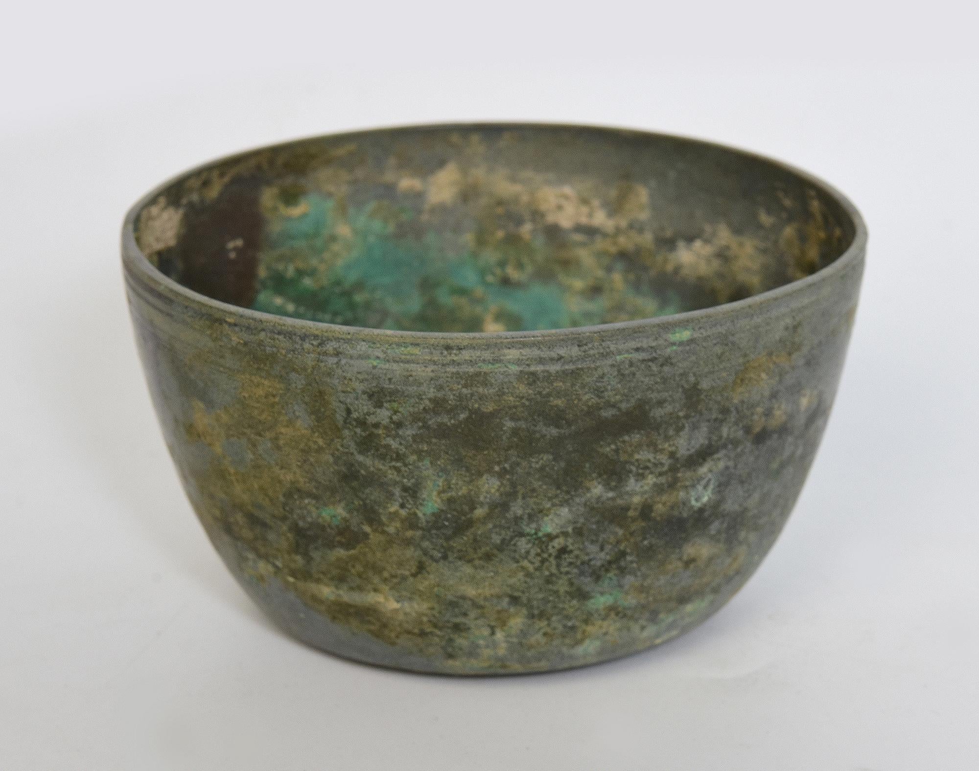 Antique Khmer bronze bowl with nice patina.

Age: Cambodia, Angkor Vat period, 12th Century
Size: Diameter 11.4 C.M. / Height 6.3 C.M.
Condition: Nice condition overall (some expected degradation due to its age).

100% satisfaction and authenticity