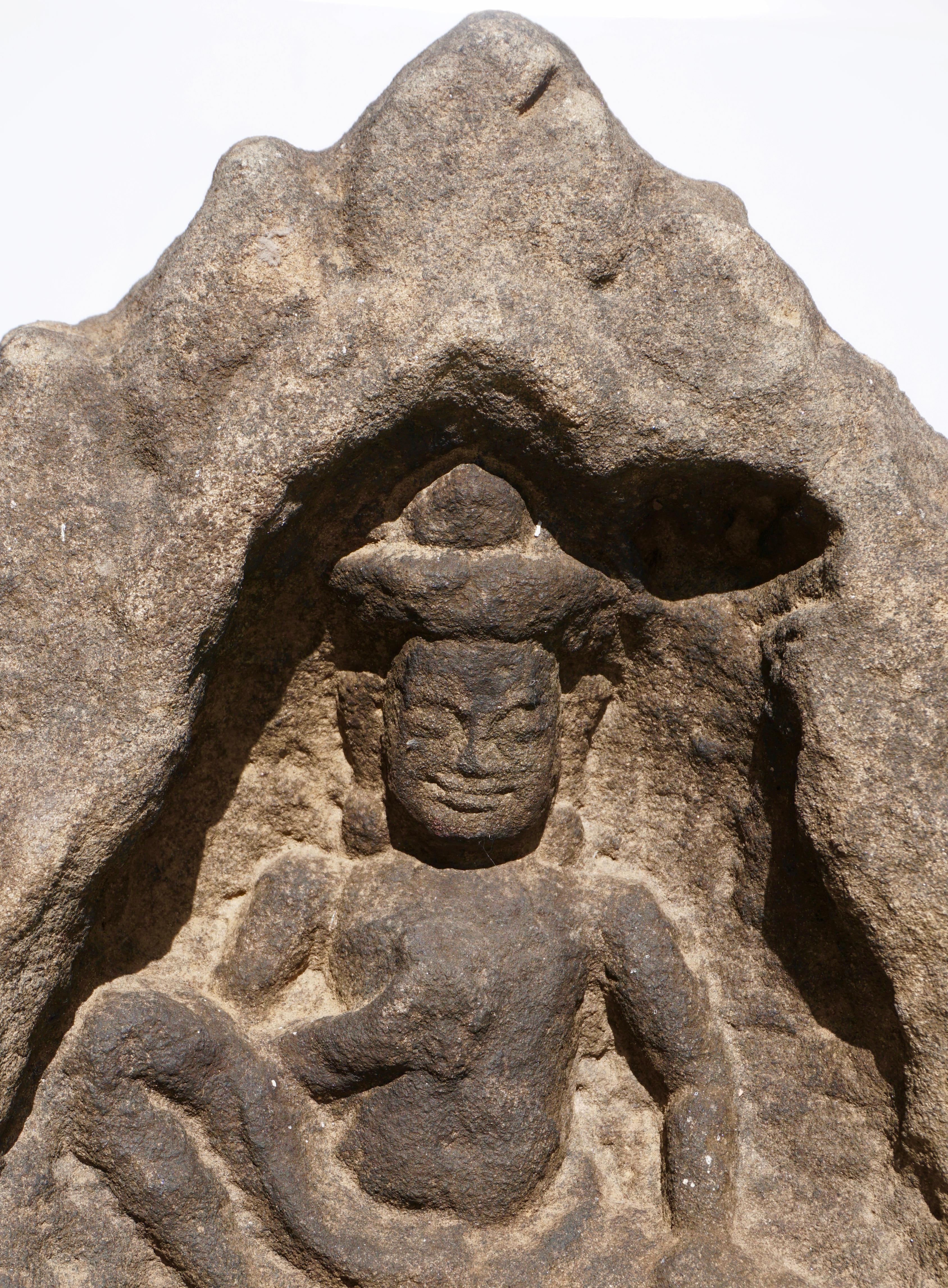 A large Cambodian Angkor Wat attributed sandstone stone fragment of an Apsara Buddha shrine with flame crown, 12th century. 

Measures: Height 12 inches (30 cm)
Width: 10 inches (25.5 cm) 

Provenance: From a Canadian auction selling the estate of a