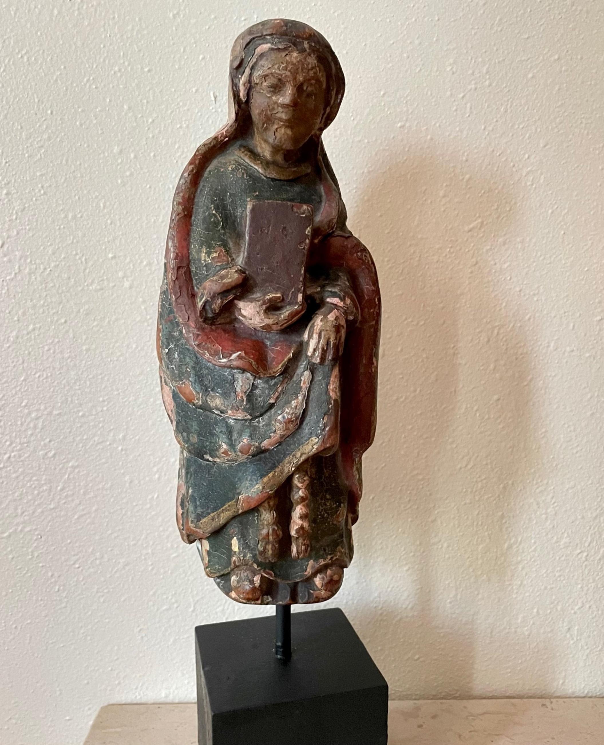 12th century extremely rare romanesque wood sculpture of the Virgin Mary.

Magnificent wood hand carved sculpture of the Virgin Mary holding a book to her chest. 
It is an extremely rare survivor of the 12th century. The style is European, possibly