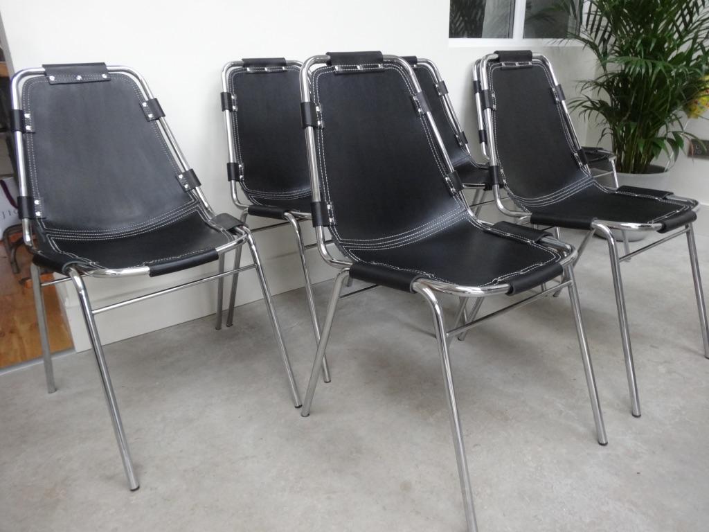 Vous ne trouverez pas d'autre ensemble de 12 chaises en cuir noir comme celui-ci sur un autre site web dans le monde entier ! Sélectionné par Charlotte Perriand pour la station de ski des Arcs, vers 1960. Très belle structure tubulaire chromée avec