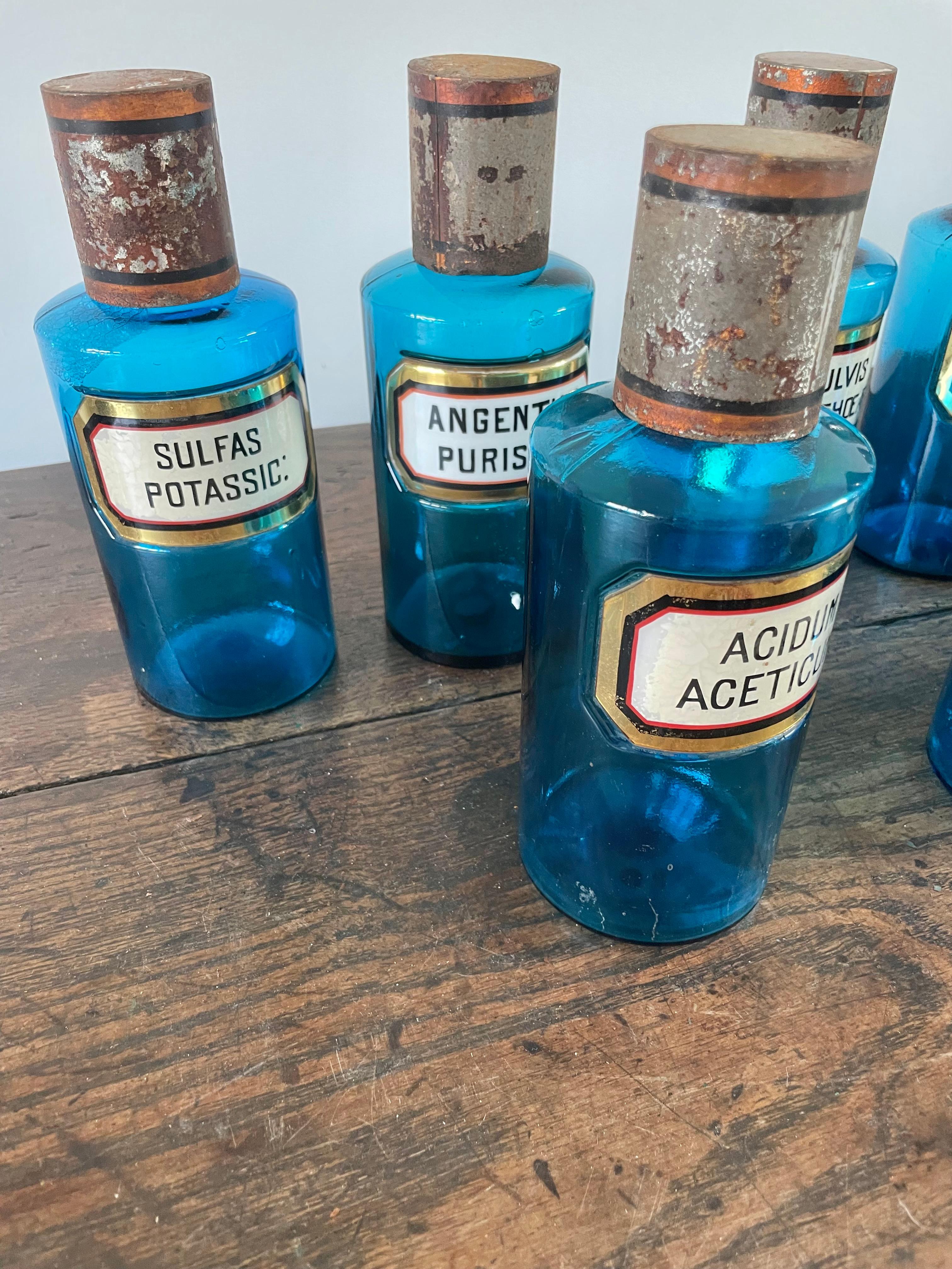 Glass 13 antique blue glass apothecary bottles For Sale