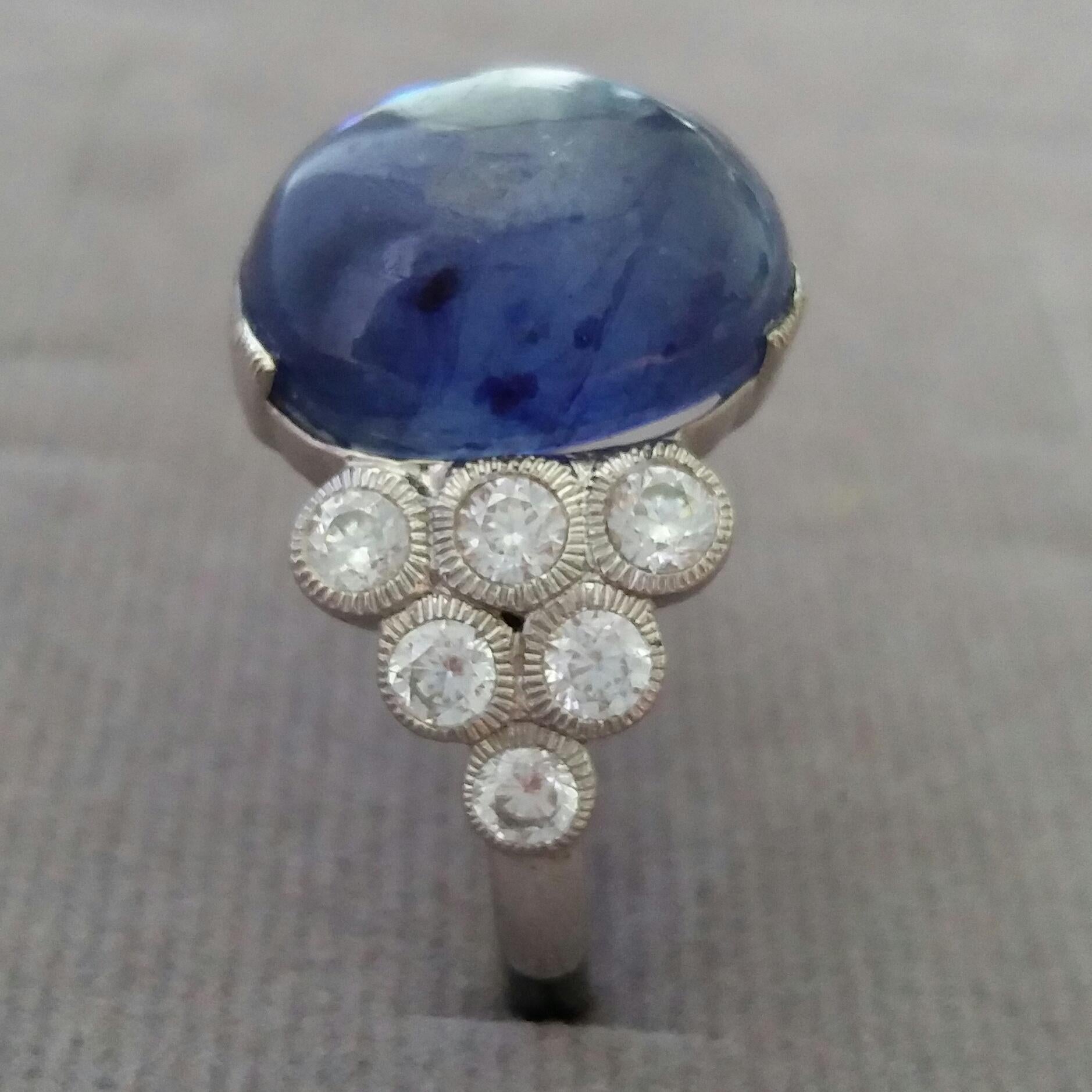 13 Carats Blue Sapphire oval cab ( 13,4 mm. x 11,3 mm.) set with 3,5 grams of 14 kt white gold, 12 round full cut diamonds of 0,05 ct. each = 0,6 carats total diamonds weight
Ring Shank Diameter  21 mm
Height 25 mm
Weight  6 grams
In 1978 our