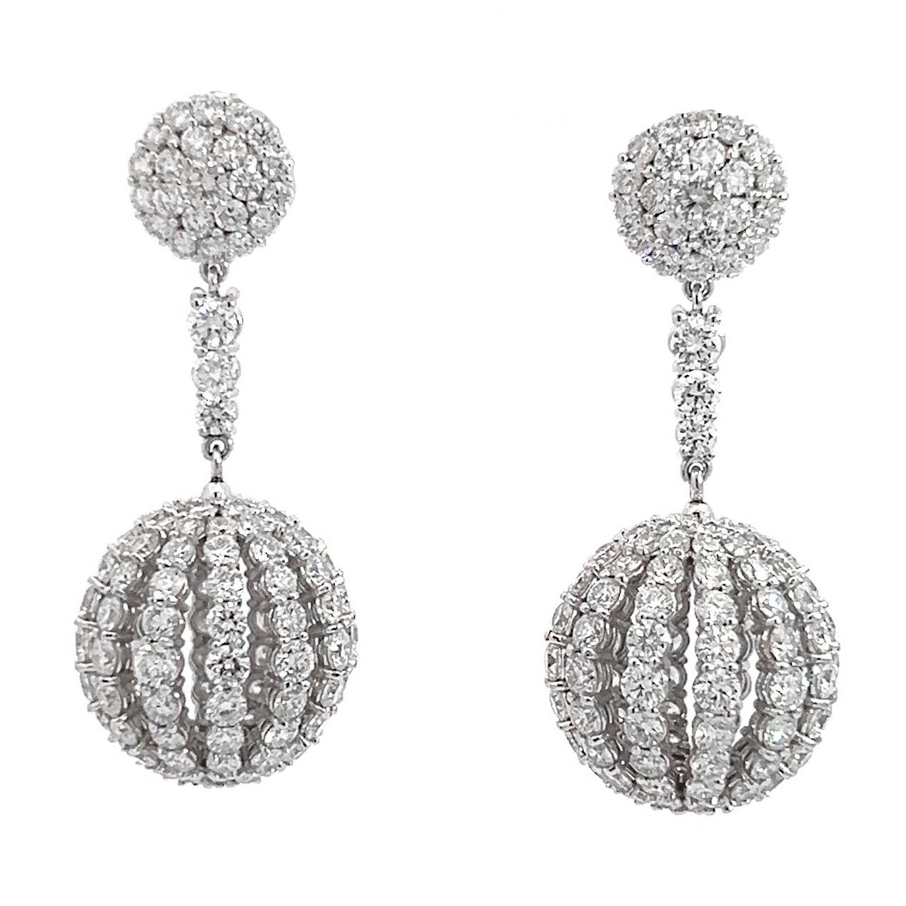 18-karat white gold diamond sphere earrings. This exquisite pair of dangle earrings boasts a dazzling array of 300 round brilliant white diamonds, totaling 13 carats. 
Crafted with meticulous attention to detail, each earring features a paved stud