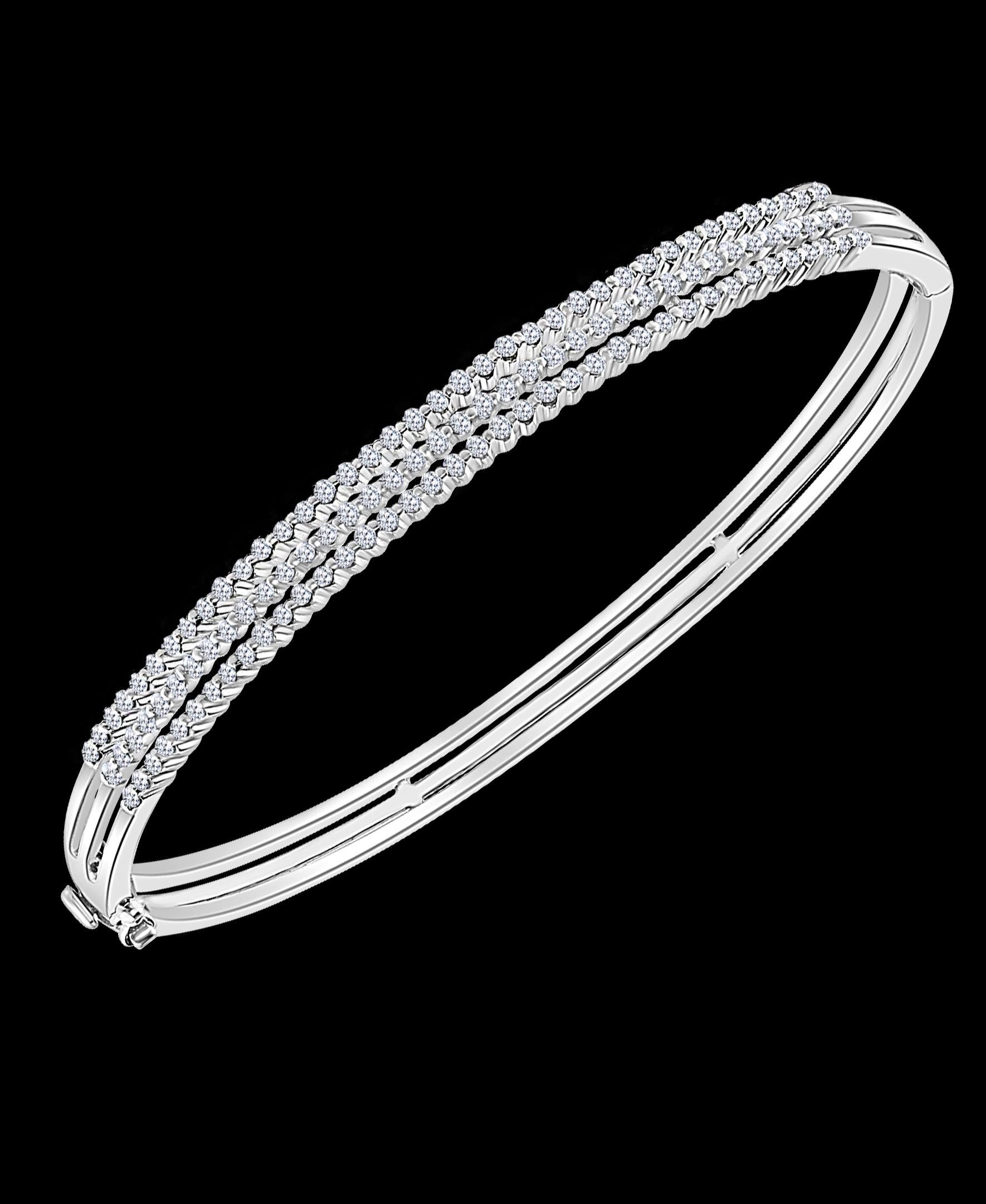1.3 Carat Diamond Bangle /Bracelet in 18 Karat White Gold 15 Grams
It features a bangle style Bracelet crafted from 18 karat White gold and embedded with total approximately 1.3 Carats with Round brilliant diamonds . 
Three Rows of diamonds.
Open