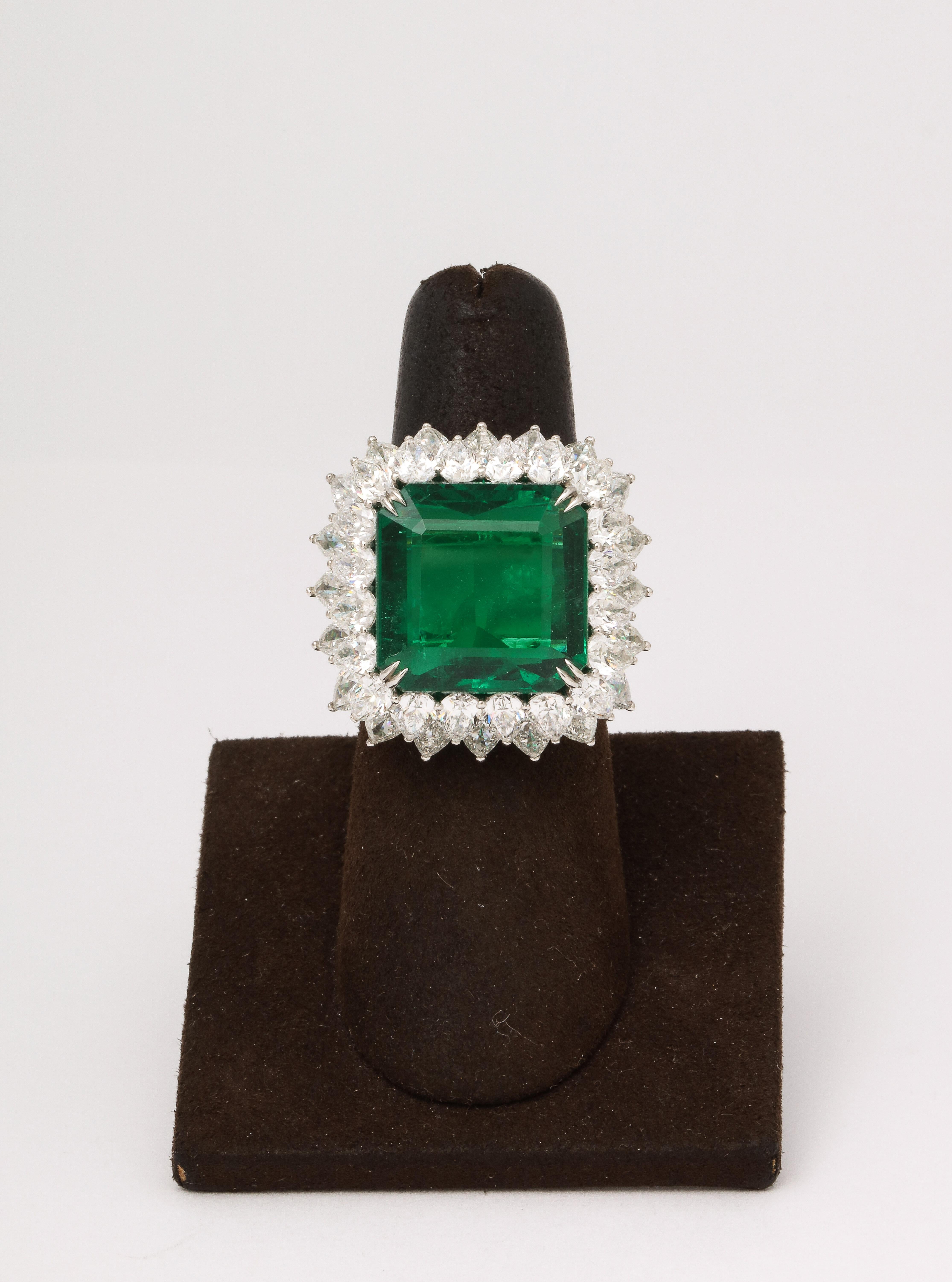 
A MAGNIFICENT ring! 

GIA Certified Fine 13.20 carat Emerald cut Emerald set with 2 rows of white pear shape diamonds weighing 9.13 carats. 

Meticulously designed and set in platinum. 

The ring is just under an inch in length and width.